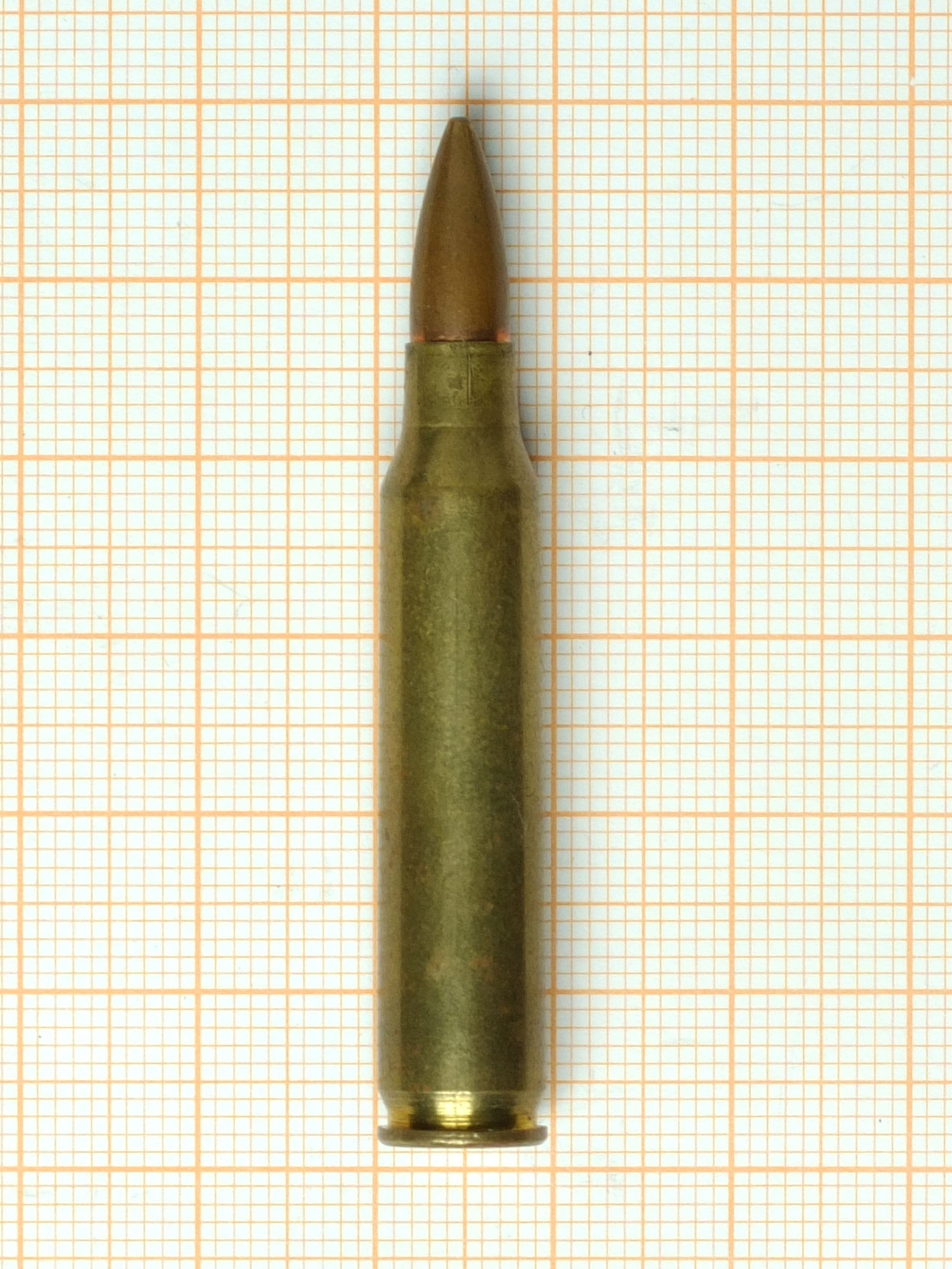 Figure 4 — A single 5.56×45mm NATO round. The case is dimensionally interchangeable with .223 Remington; the chamber it is fired in is not.