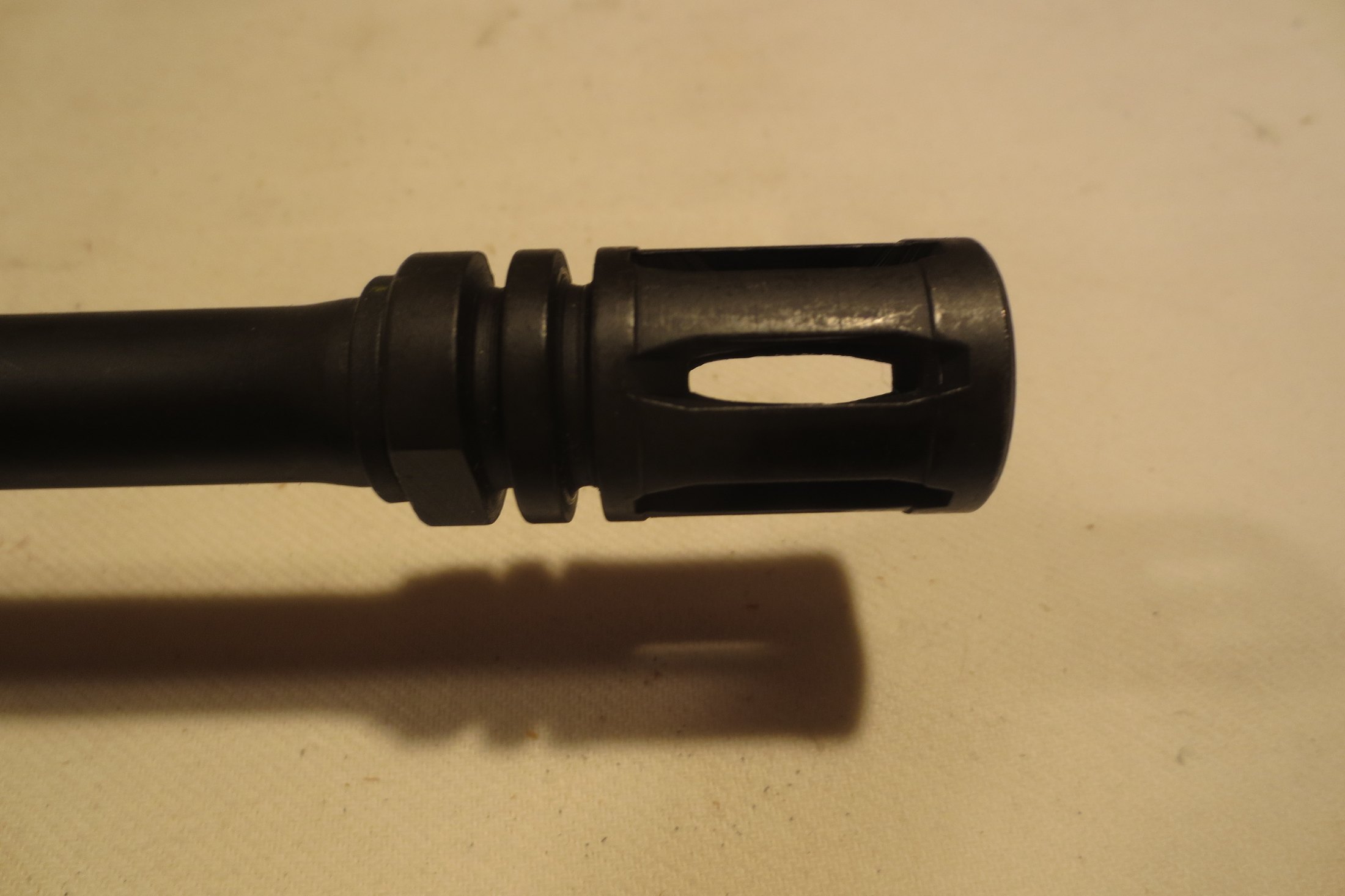 Figure 7 — The flash hider of an M16A1. The closed-bottom A2 pattern that succeeded it added a solid lower surface to reduce dust signature when firing prone.