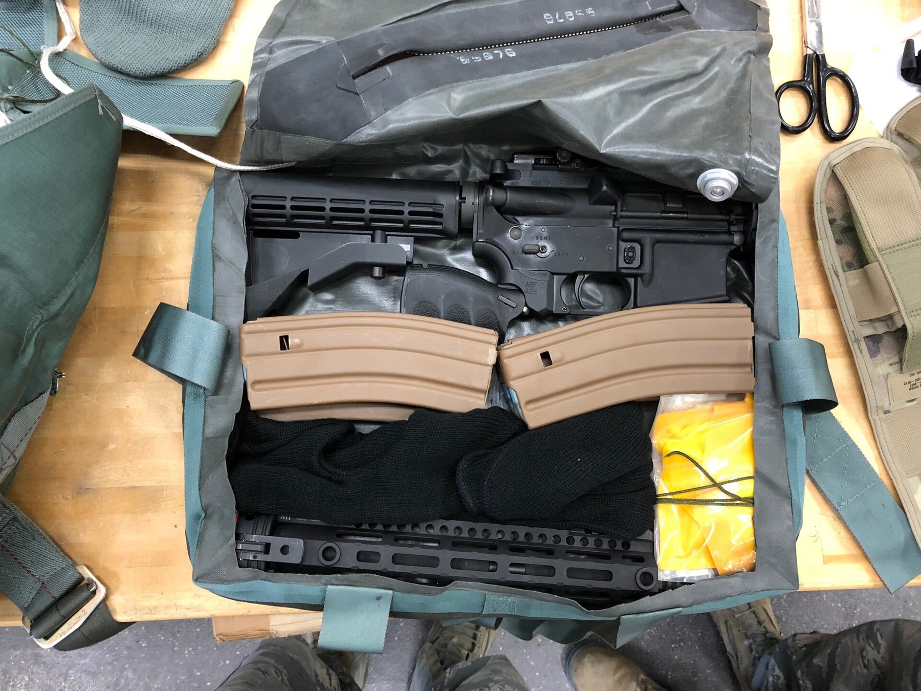 Figure 5 — A GAU-5A aircrew self-defence weapon packed into an ejection-seat survival kit, with its magazines. The modern Air Force answer to the question the AR-5 answered in 1956: still a take-apart rifle p…