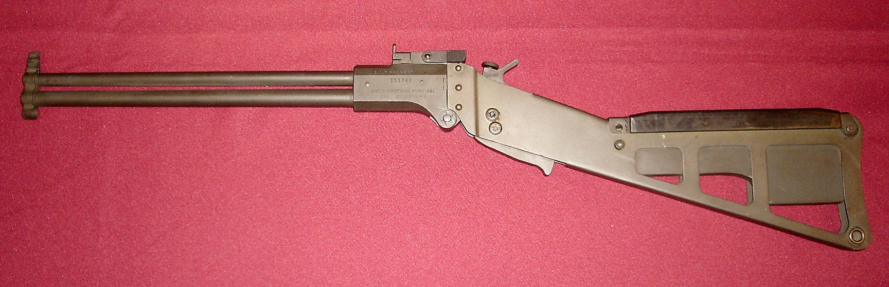 Figure 3 — The Ithaca M6 aircrew survival weapon: .22 Hornet over .410, folding at the breech, with a skeletal stock. Photograph by Curiosandrelics, CC BY-SA 3.0, via Wikimedia Commons.