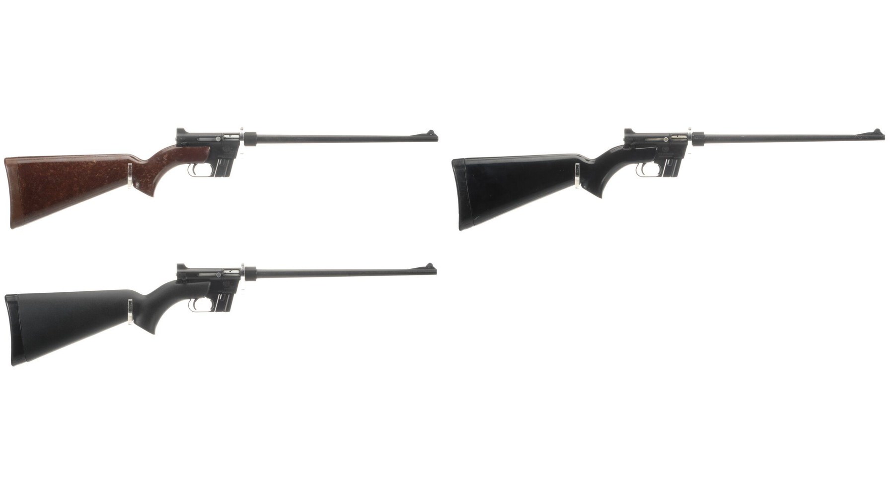 Figure 2 — Three AR-7 carbines sold together as ArmaLite, one with a mottled brown stock and two with black. The metal is the same on all three; the stock colour is what varies, and brown is the colour collec…