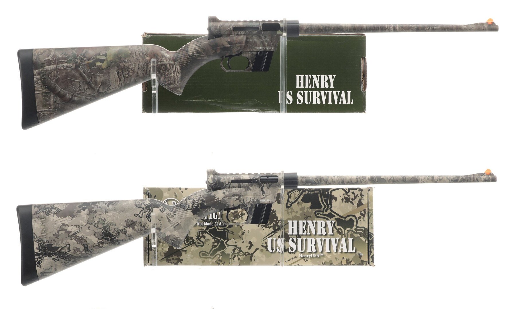 Figure 5 — Two Henry U.S. Survival rifles in camouflage with their boxes. Henry's stock is textured and ribbed at the grip, the front sight is orange-tipped, and the barrel is steel covered in coated ABS. Roc…