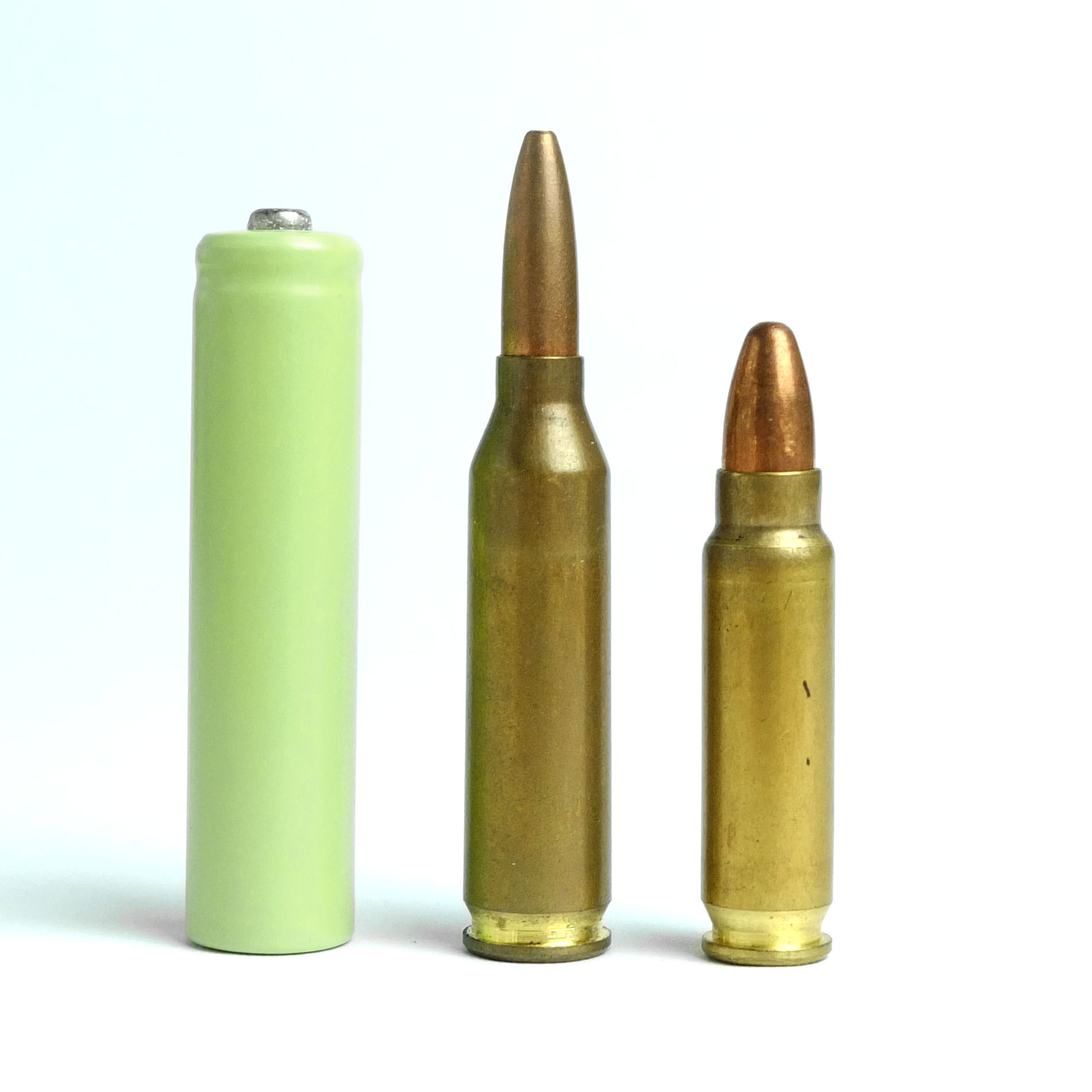 Figure 10 — Two 5.7×28mm cartridges beside a 4.6×30mm for scale. The economics of feeding this weapon are set by the cartridge on the left, and by the fact that nothing else chambers it.