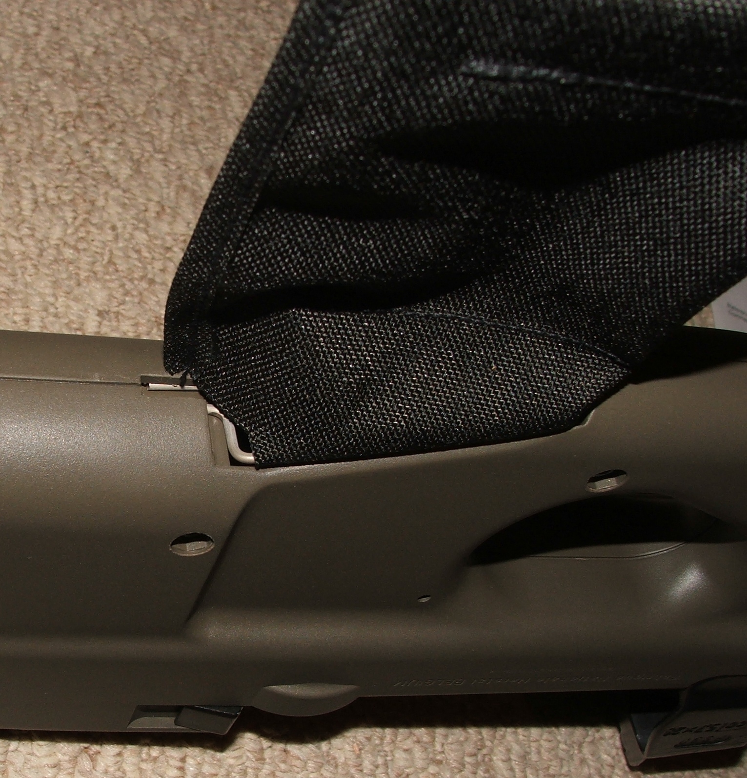 Figure 7 — A brass catcher fitted to the ejection chute behind the grip. The pouch hangs directly below the weapon because that is where the cases go.