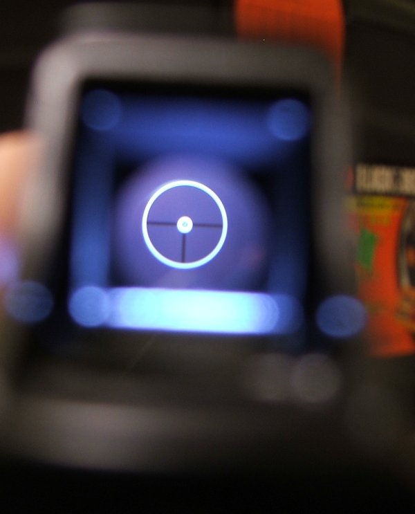 Figure 7 — The reflex sight picture in daylight. Coarse, bright, and fast to pick up — a deliberate design point rather than a limitation.