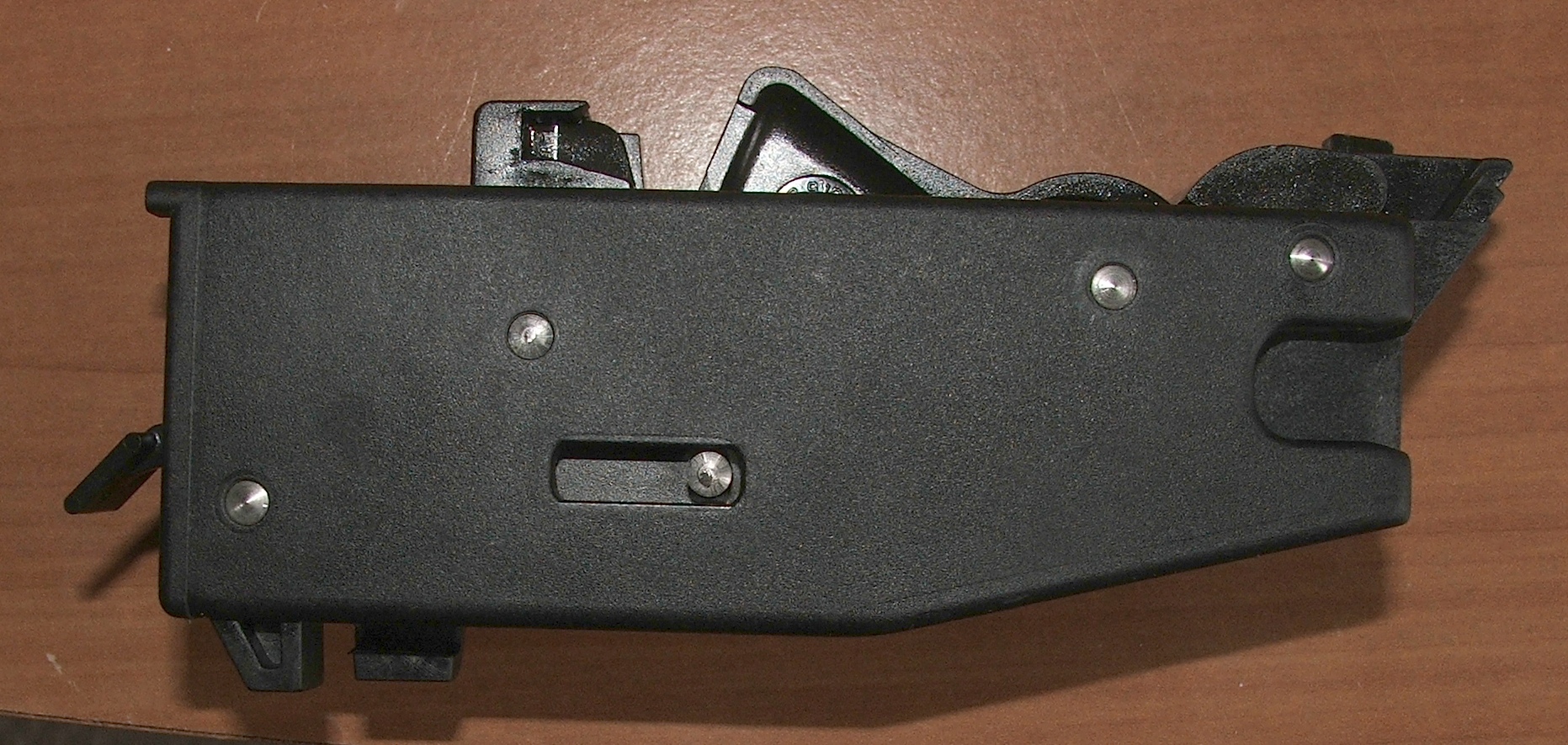 Figure 7 — The same group from the other side. The mechanism is conventional and inspectable; the linkage that reaches it from the trigger is what makes the pull what it is.