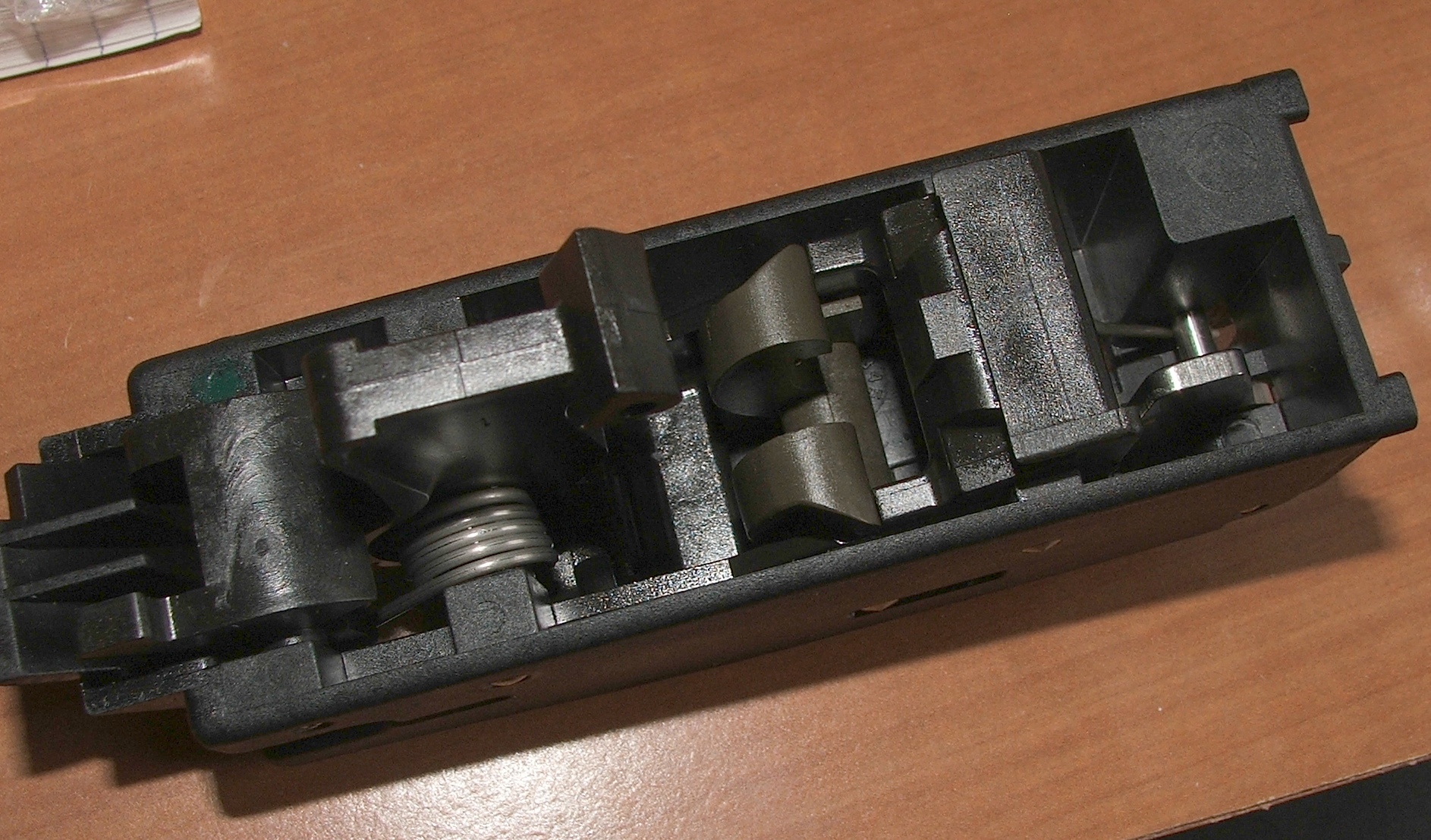 Figure 5 — Inside the fire-control group. The mechanism itself is conventional; the distance between it and the trigger is the design compromise.
