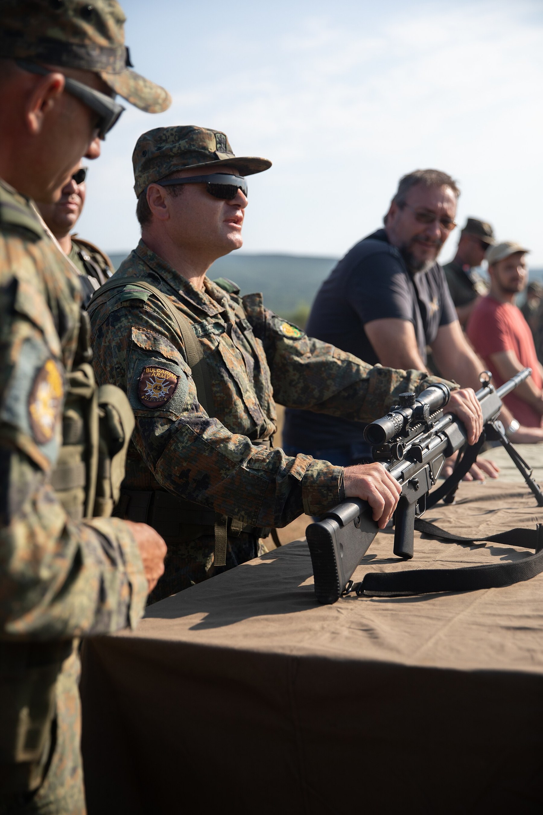 Figure 3 — A Bulgarian soldier demonstrates the HK MSG90 during a multinational weapons exchange at Exercise Platinum Lion, Novo Selo, Bulgaria, July 2022. US Army photograph; the model is named in the Army's…