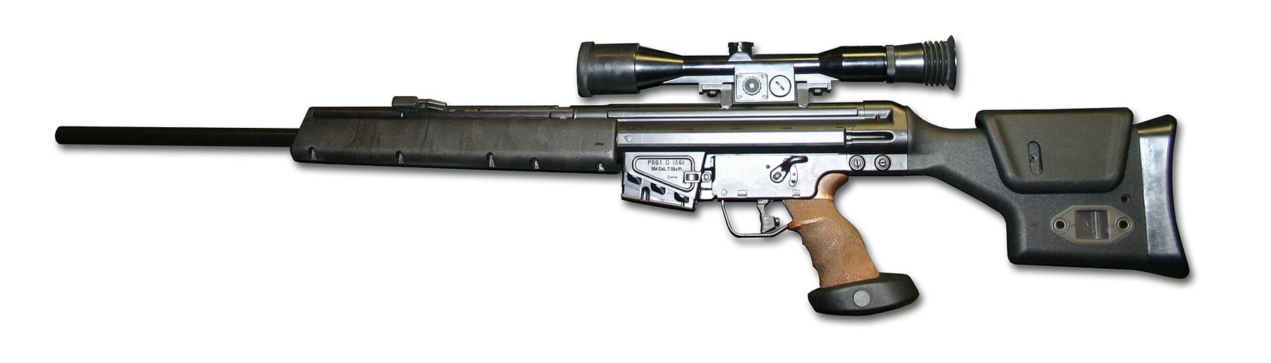 Figure 1 — A Heckler and Koch PSG1, left side, photographed at a 2014 display: the heavy barrel with no sights, the long handguard, the fixed scope mount on top of the receiver, the 20-round magazine, the woo…