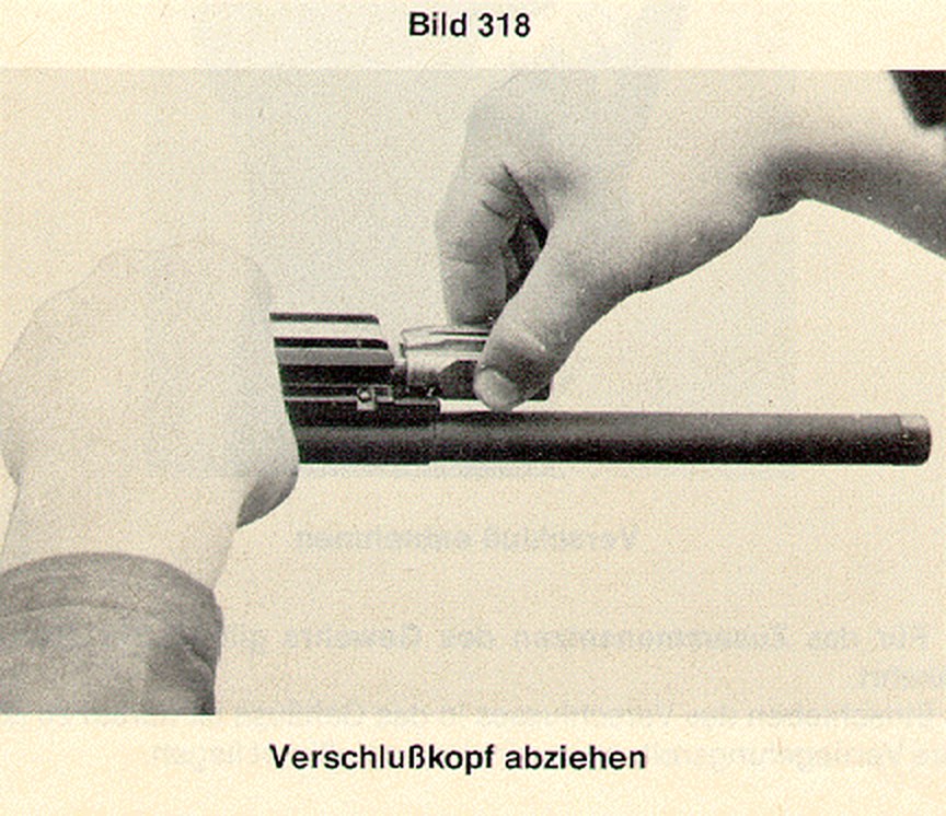 Figure 6 — Bolt strip, step one: holding the carrier in one hand, the bolt head is rotated and drawn off the control piece.
