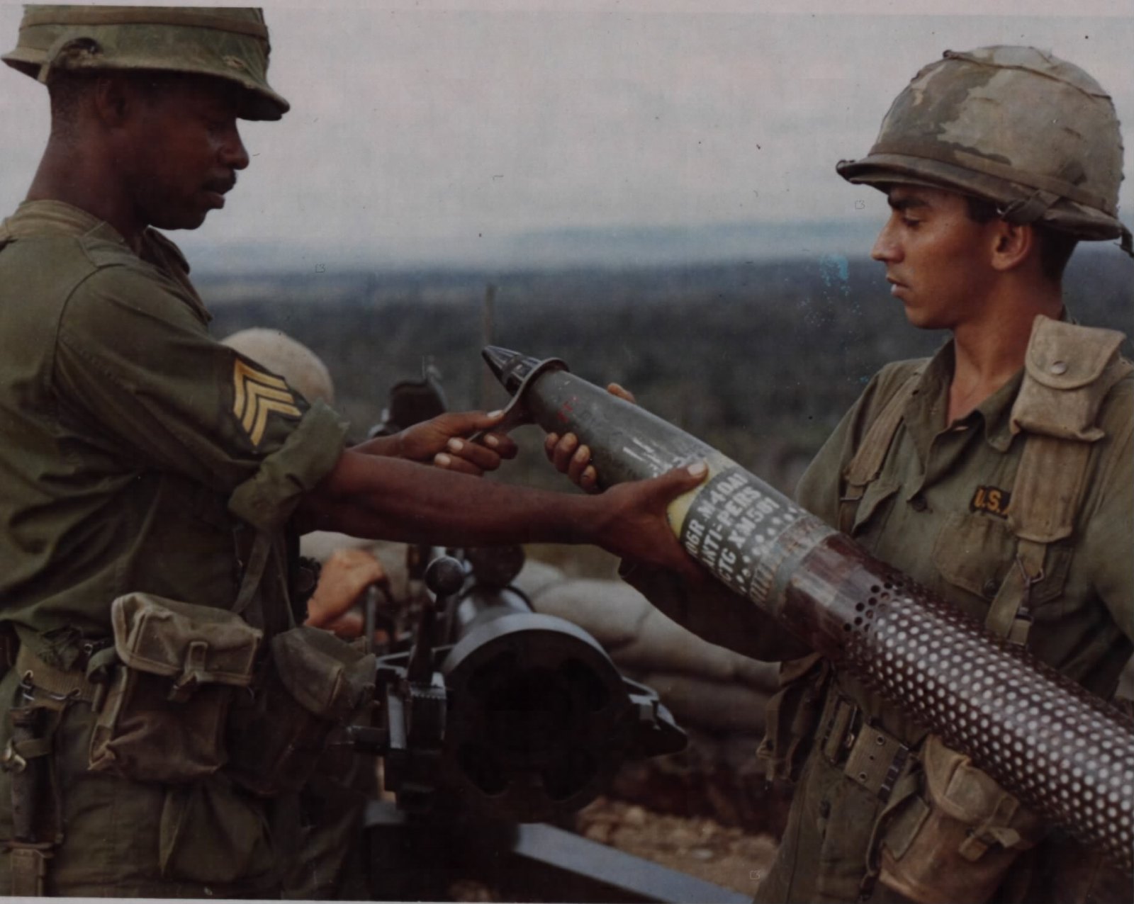Figure 3 — Soldiers of Company B, 5th Battalion, 7th Cavalry, 1st Cavalry Division (Airmobile), setting the timing on a 106 mm XM581 Beehive anti-personnel round at An Khe, 31 January 1967. Beehive rounds dis…