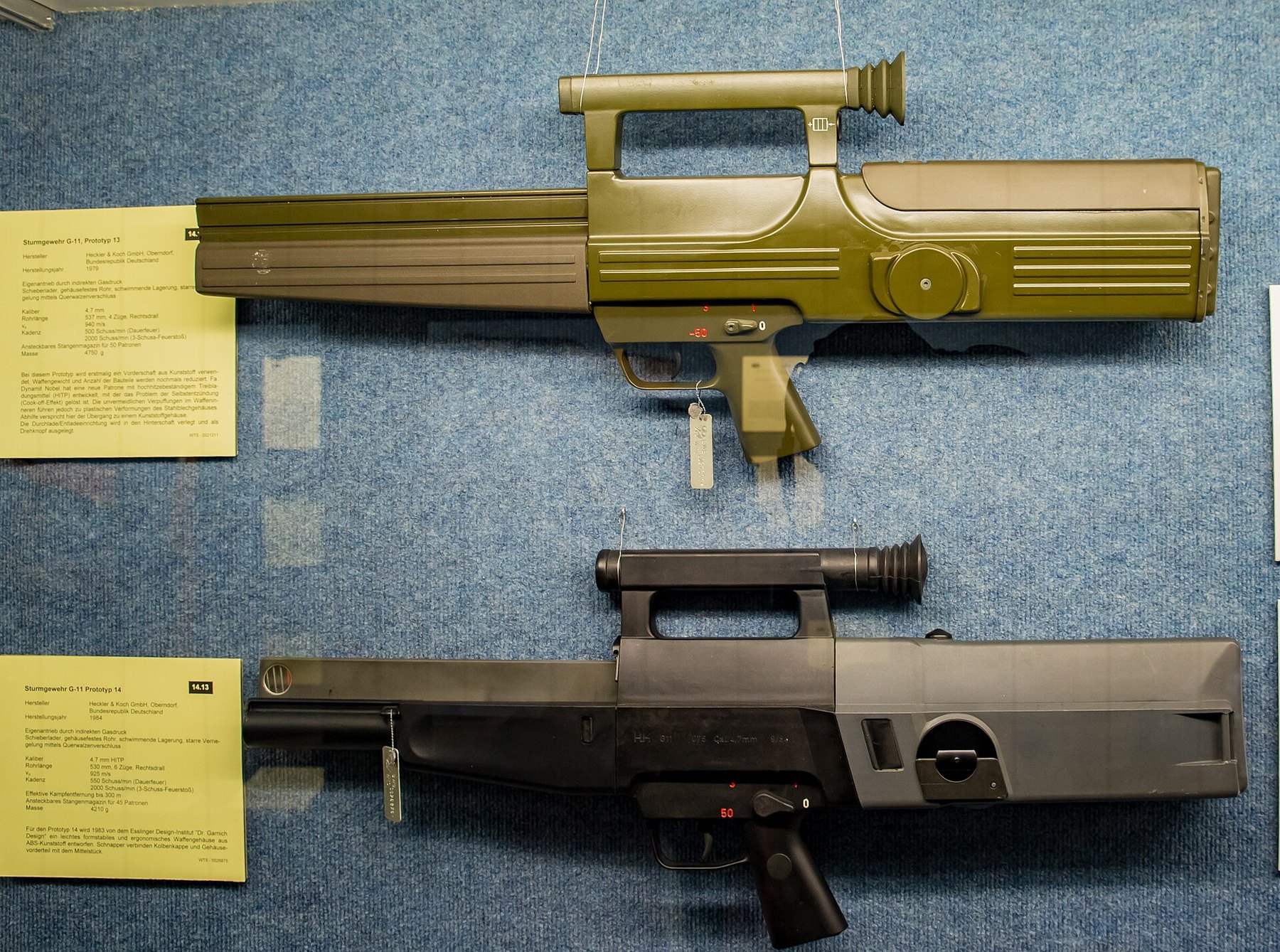 Figure 1 — Two of the G11 prototypes in the Bundeswehr's Wehrtechnische Studiensammlung at Koblenz. Top: Prototype 13 of 1979, olive, the first with a plastic forend. Bottom: Prototype 14 of 1984, black, with…