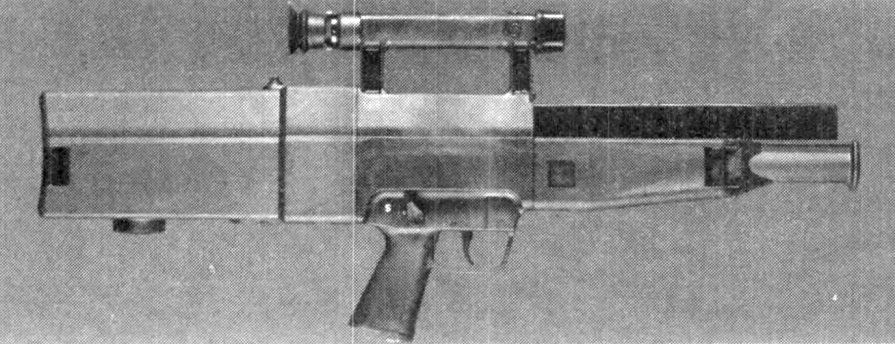 Figure 3 — A G11 at the US Army's Advanced Combat Rifle test, as photographed for the Army in 1989: the long slab housing, the carrying handle that is also the sight, the magazine running along the top above …