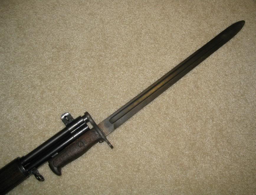 Figure 4 — A wartime 16-inch bayonet fixed on an M1. The ring sits over the muzzle and the pommel is latched onto the lug under the gas cylinder. — Photograph: Mateusz Demański, CC BY-SA 4.0, via Wikimedia Co…