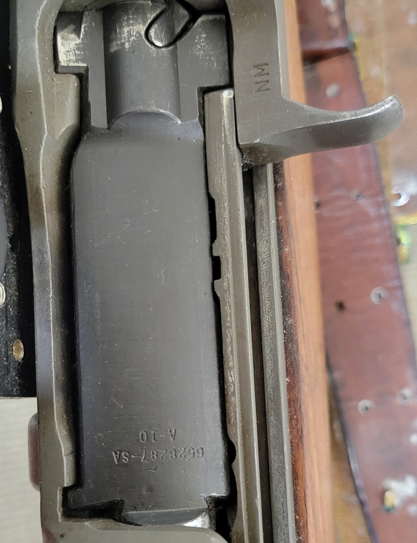 Figure 8 — Looking down into the receiver: the bolt, marked 6528287-SA with the lot code A-10, and the operating rod handle stamped NM.