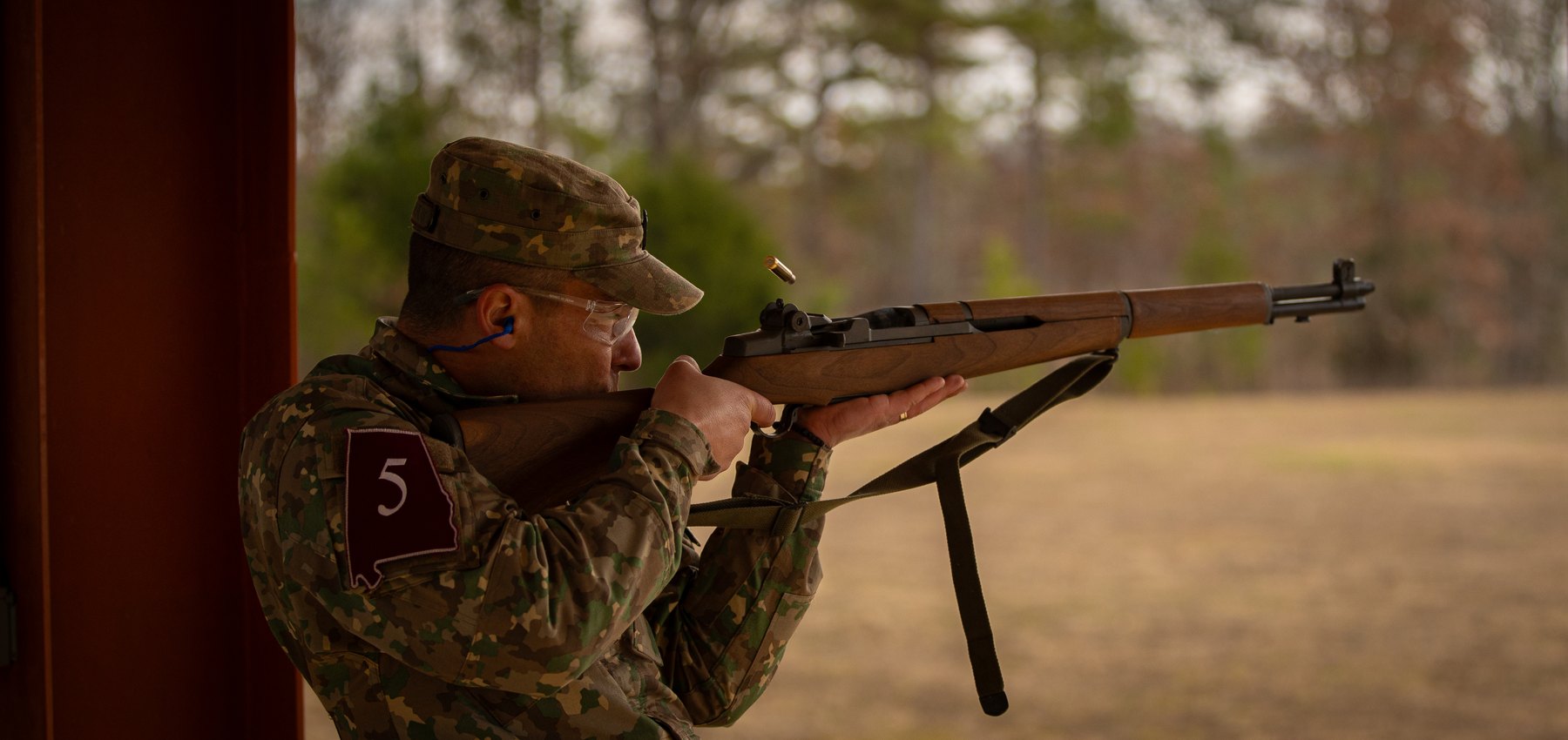 Figure 5 — A Romanian Army sergeant major fires an M1 at the Civilian Marksmanship Program's Talladega range in December 2023, as a surprise final event of the Best Warrior competition. Eighty-seven years aft…