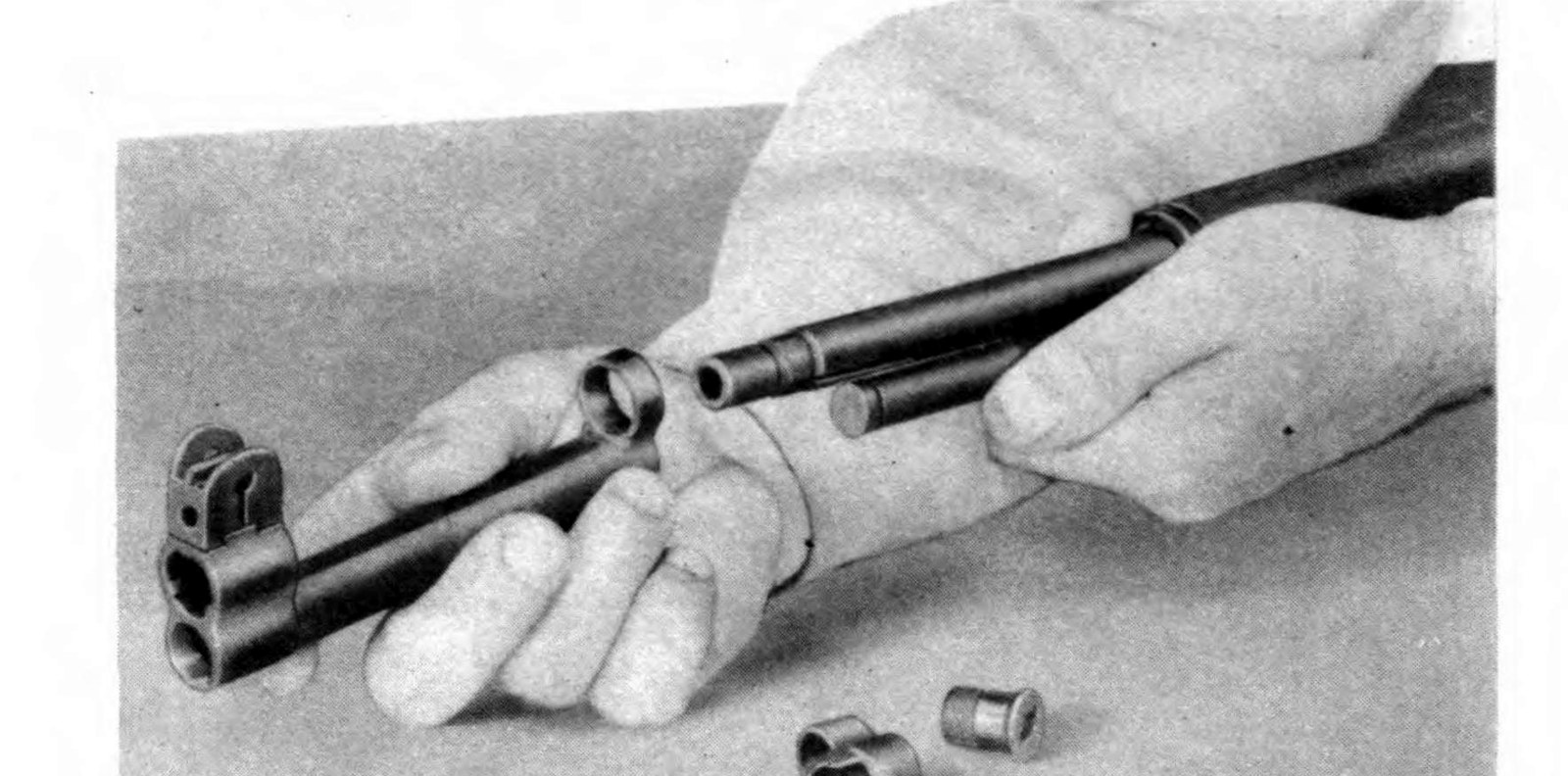Figure 3 — Taking the spline-type gas cylinder group off the barrel: the lock screw, the lock, and the cylinder itself. — U.S. War Department, TM 9-1275 (1942), Figure 27; public domain, via the Internet Arch…