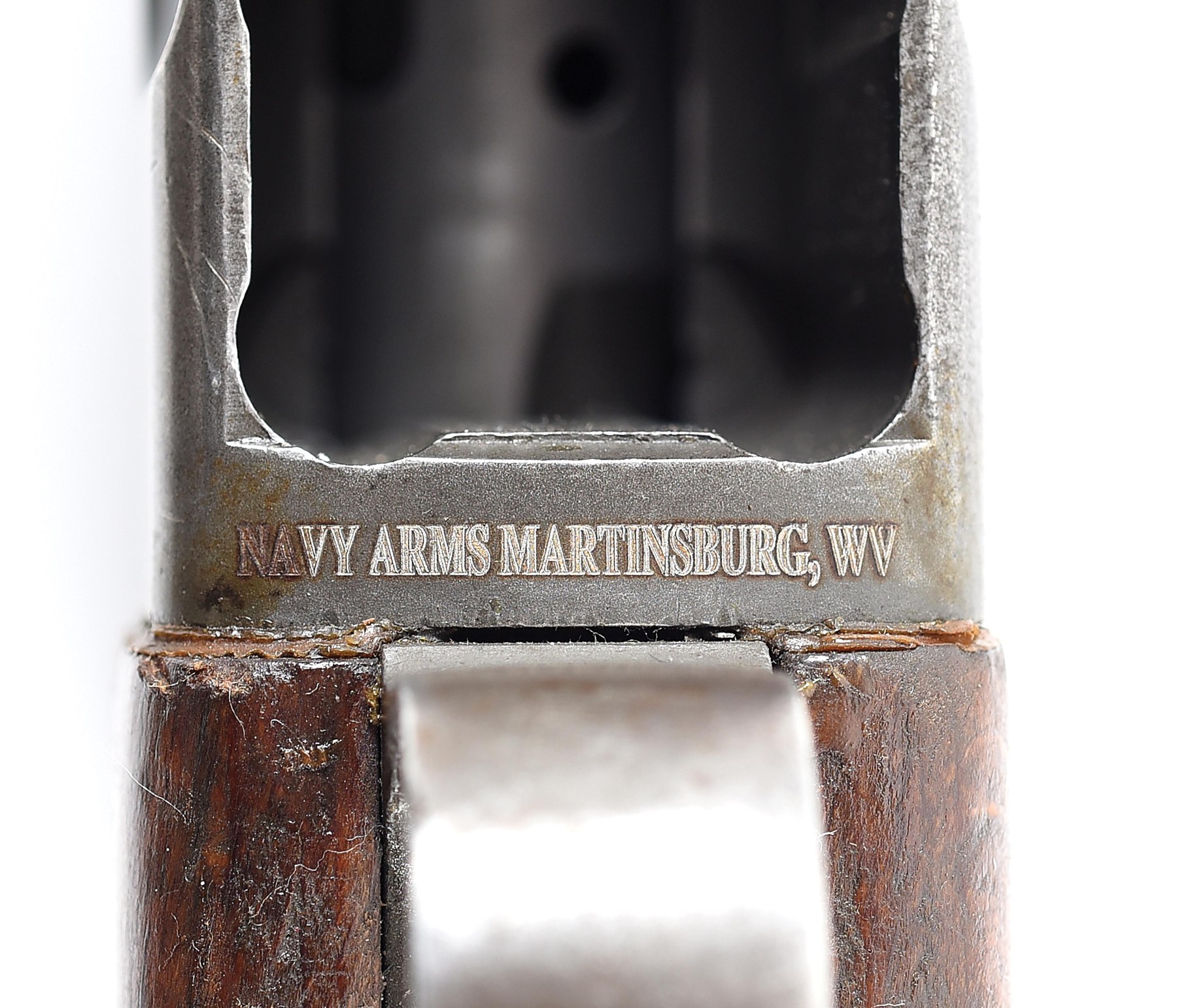 Figure 7 — The importer's mark on the same rifle, "NAVY ARMS MARTINSBURG, WV", engraved on the underside of the receiver at the magazine well, seen from below. The photograph gives the wording the LSB listing…