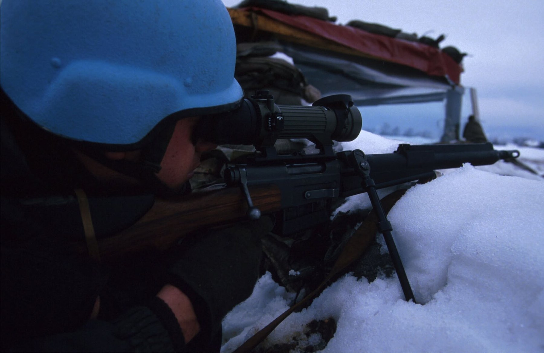 Figure 3 — A French marksman in a UN blue helmet in Sarajevo between 1 March and 30 April 1994, aiming an FR-F2 fitted with a SOPELEM OB-50 night sight. ECPAD reference 07 94 039 331. Photograph by Dominique …
