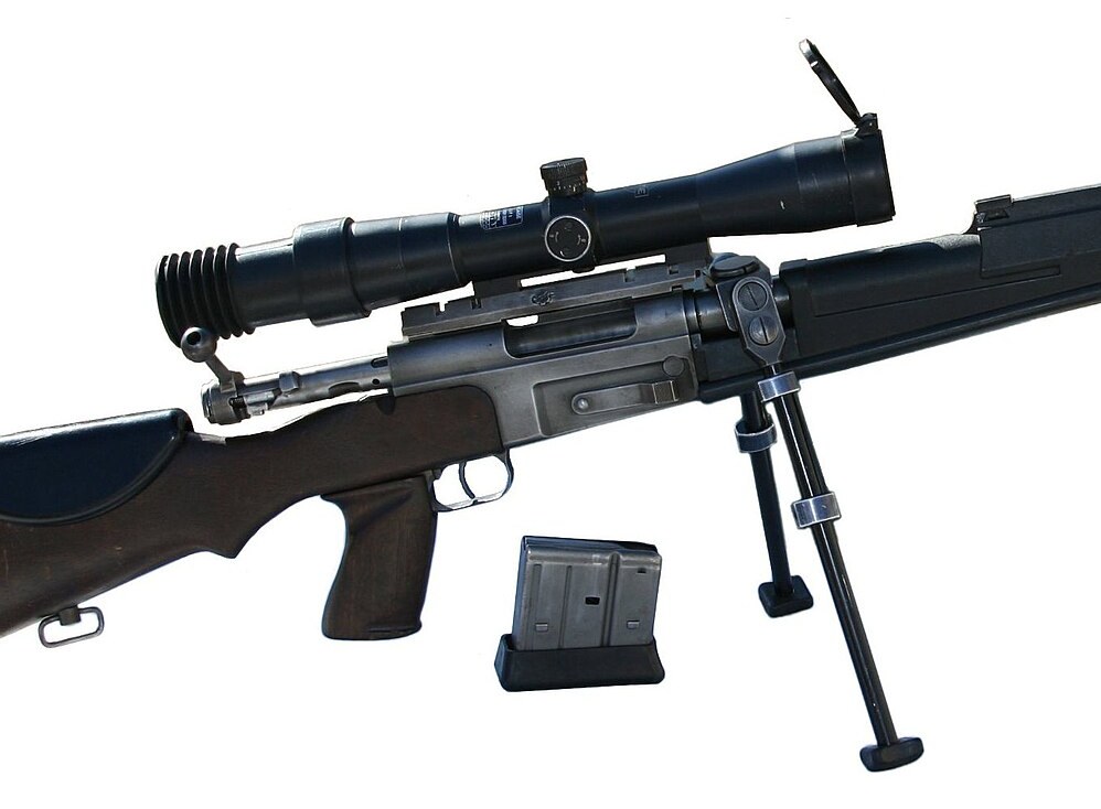 Figure 3 — The FR-F2's receiver and its fittings in close-up, from the right: the J8-pattern scope on its base, the straight bolt handle with a ball knob, the bipod yoke clamped over the barrel ahead of the r…