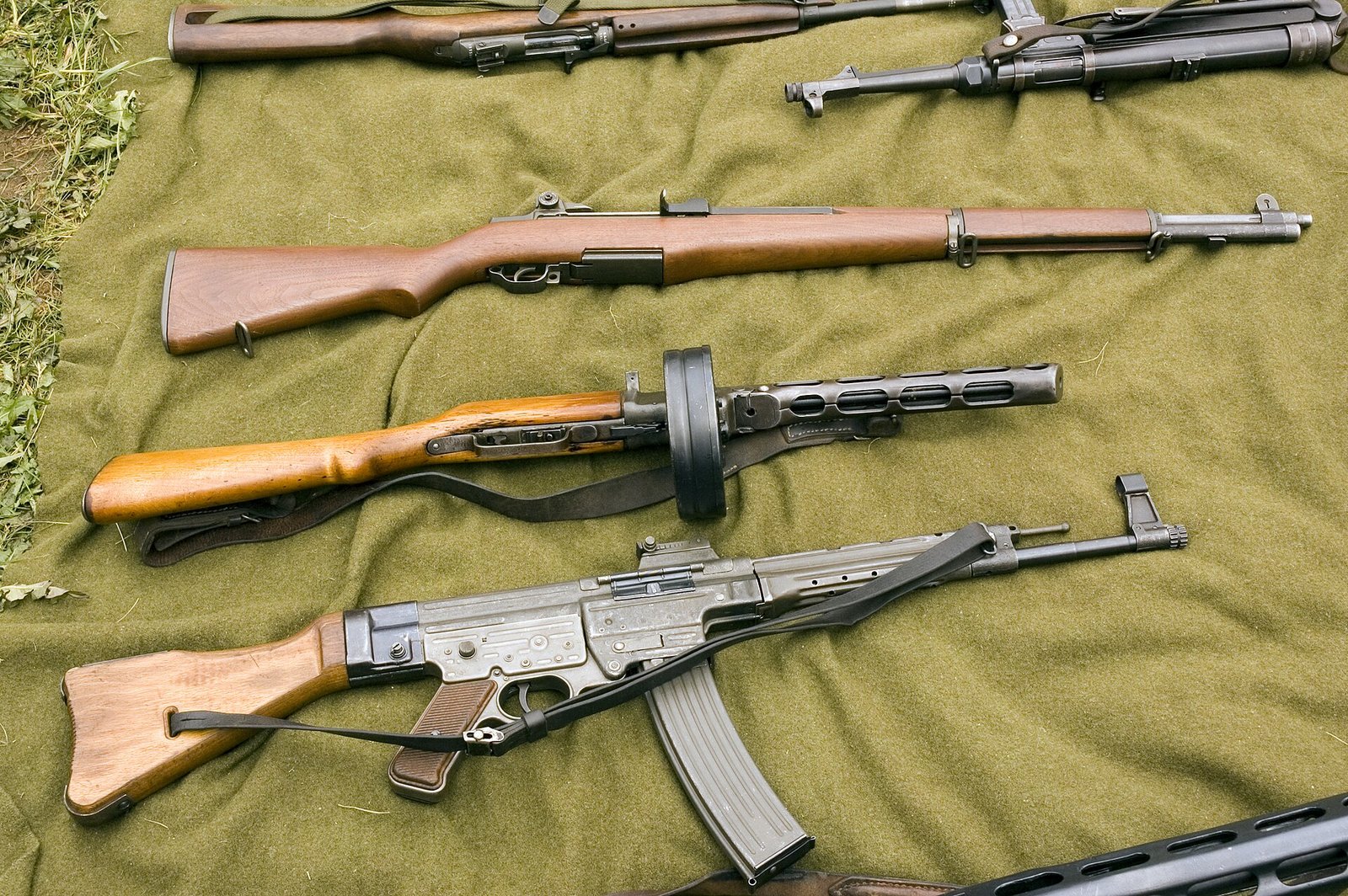 Figure 12 — An M1 Garand, a PPSh-41 and an StG 44 together. Three answers to the infantry weapon question, none of them a submachine gun — and the third of them is the German army's own verdict on the MP 40's …