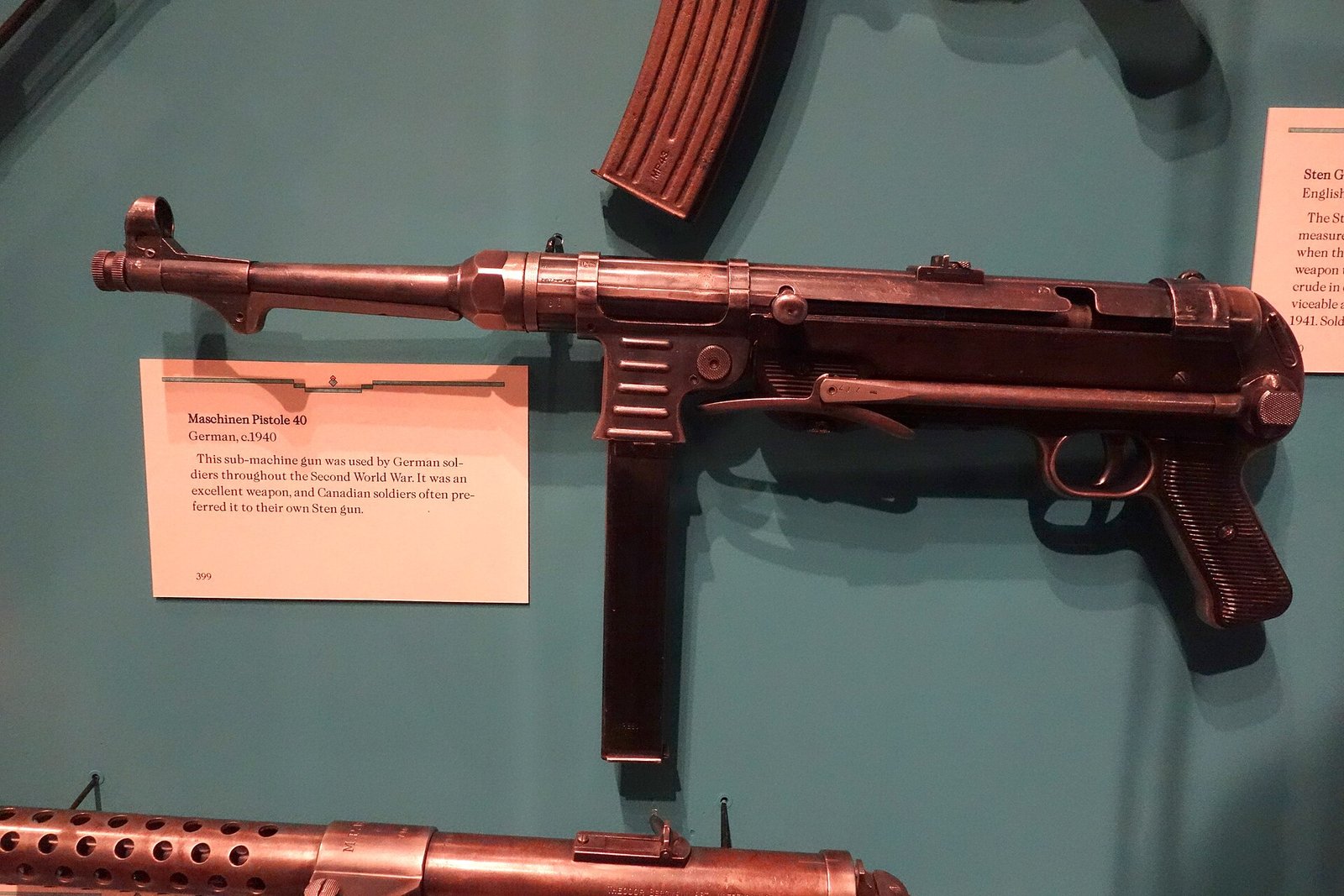 Figure 10 — An MP 40 in the Glenbow Museum with its own label, which reads in part: "This sub-machine gun was used by German soldiers throughout the Second World War. It was an excellent weapon, and Canadian s…