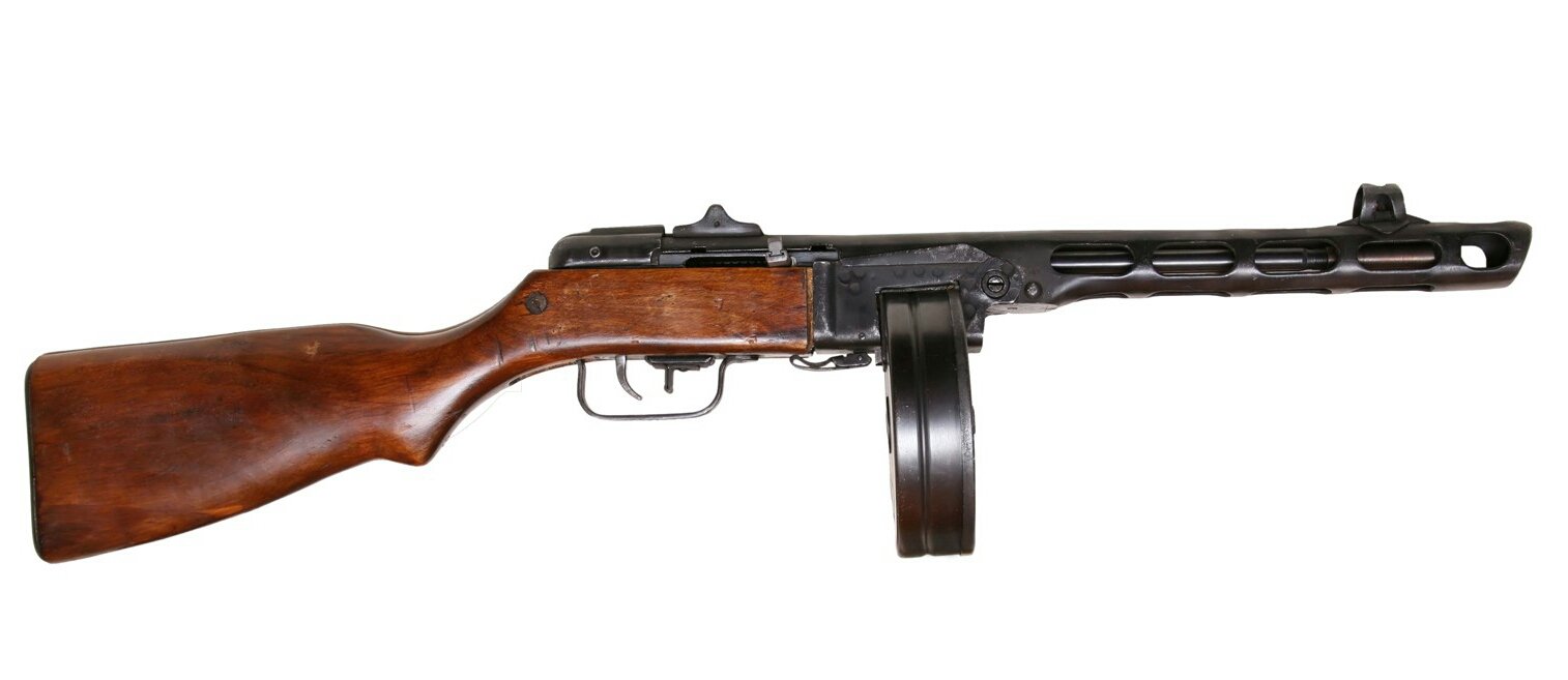 Figure 7 — A PPSh-41 with its 71-round drum. Stamped, crude, enormously prolific, and firing at two and a half times the MP 40's rate.