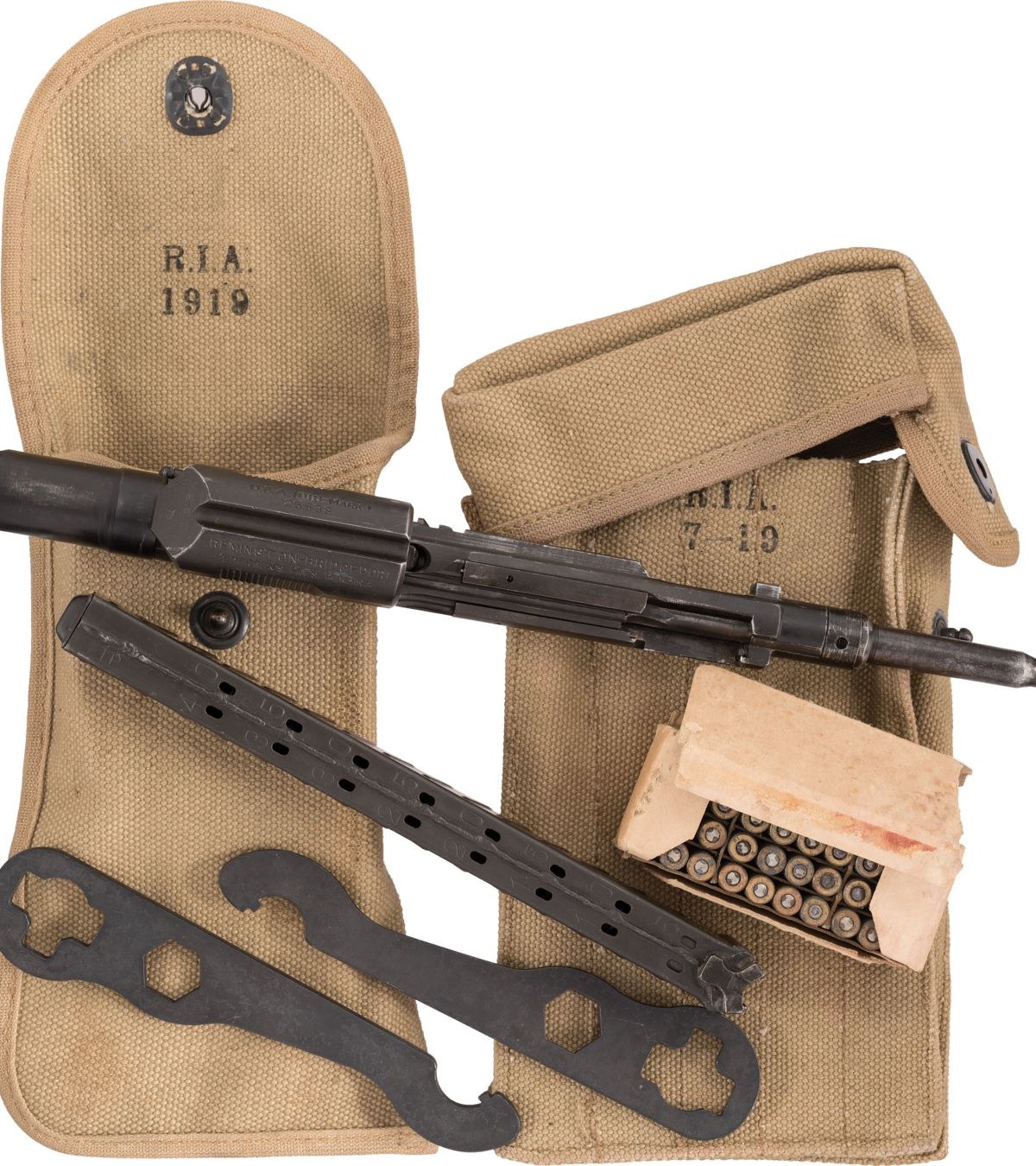 Figure 5 — A surviving outfit: the R.I.A. 1919 bolt pouch, the R.I.A. 7-19 magazine case, two of the adjustment wrenches, the device, a magazine and a box of cartridges. Rock Island Auction Company, 26 August…