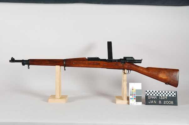 Figure 3 — The Springfield Armory museum's Mark I rifle SPAR 1324 with the device and magazine fitted, left side, photographed in 2008: the magazine stands up from the far side of the receiver and the device'…