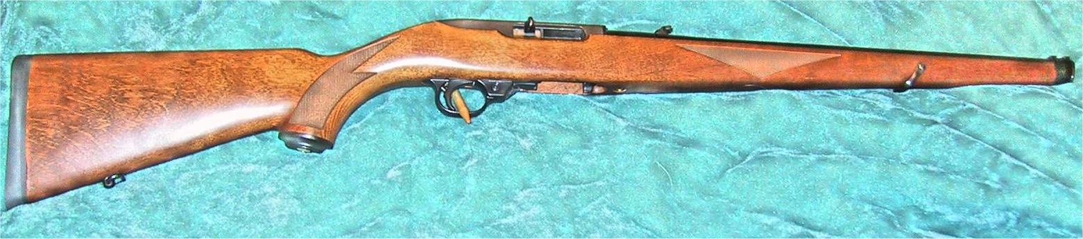Figure 1 — A 10/22 International: the full-length, Mannlicher-style stock running to the muzzle, with a muzzle cap. The same action, barrel attachment and magazine as every other 10/22 — the variants are almo…