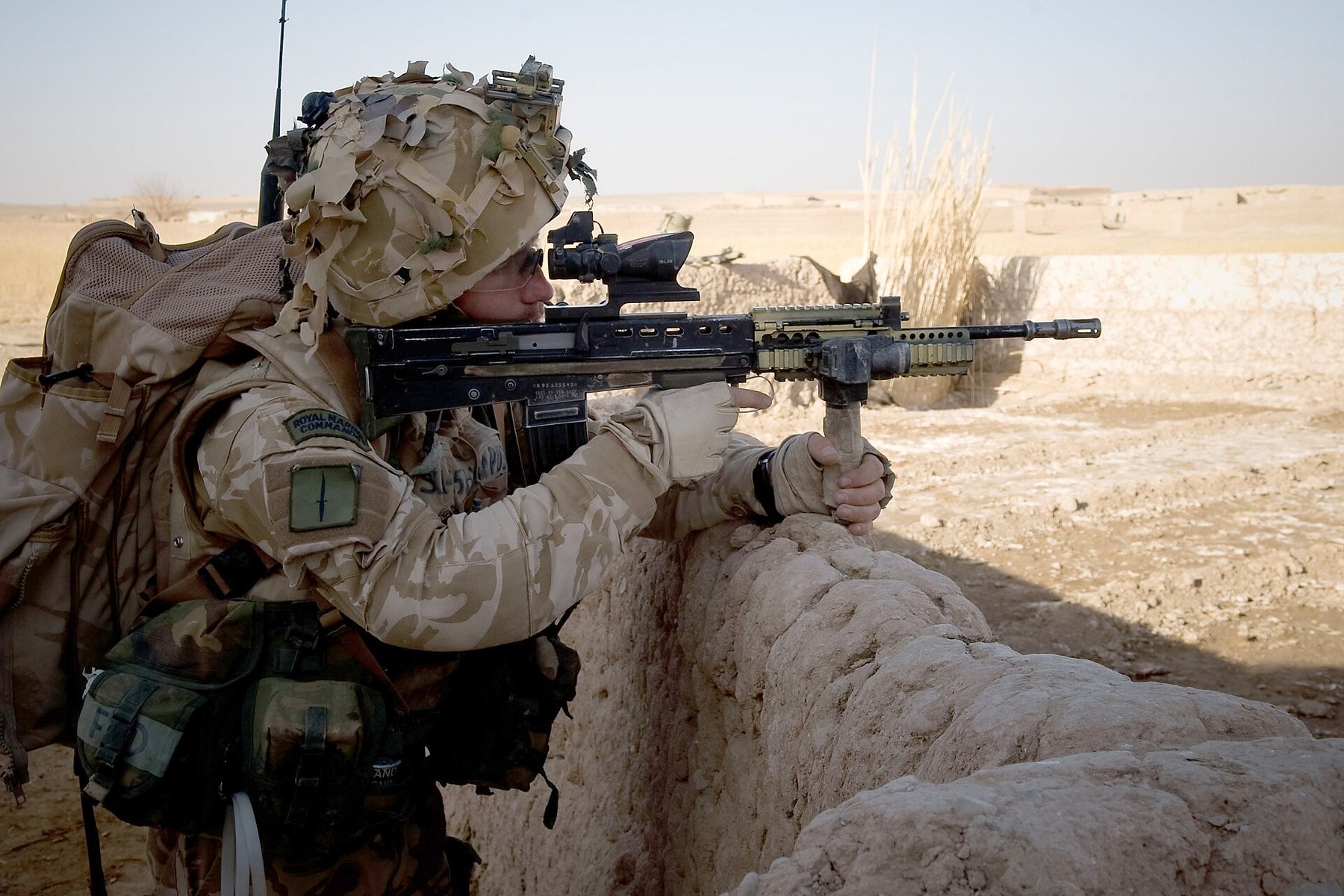 Figure 5 — A Royal Marine of 42 Commando aims an SA80 with a forward handgrip during Operation Sond Chara in Afghanistan, December 2008. The optic is a compact prism sight with a small reflex sight on top; th…