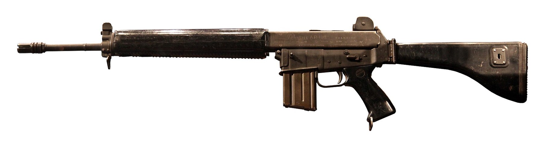 Figure 11 — An ArmaLite AR-18 on a white background, muzzle left, with its folding stock extended: the pressed-steel rifle whose gas system and working parts the 1970 study recommended as a basis. Photograph b…