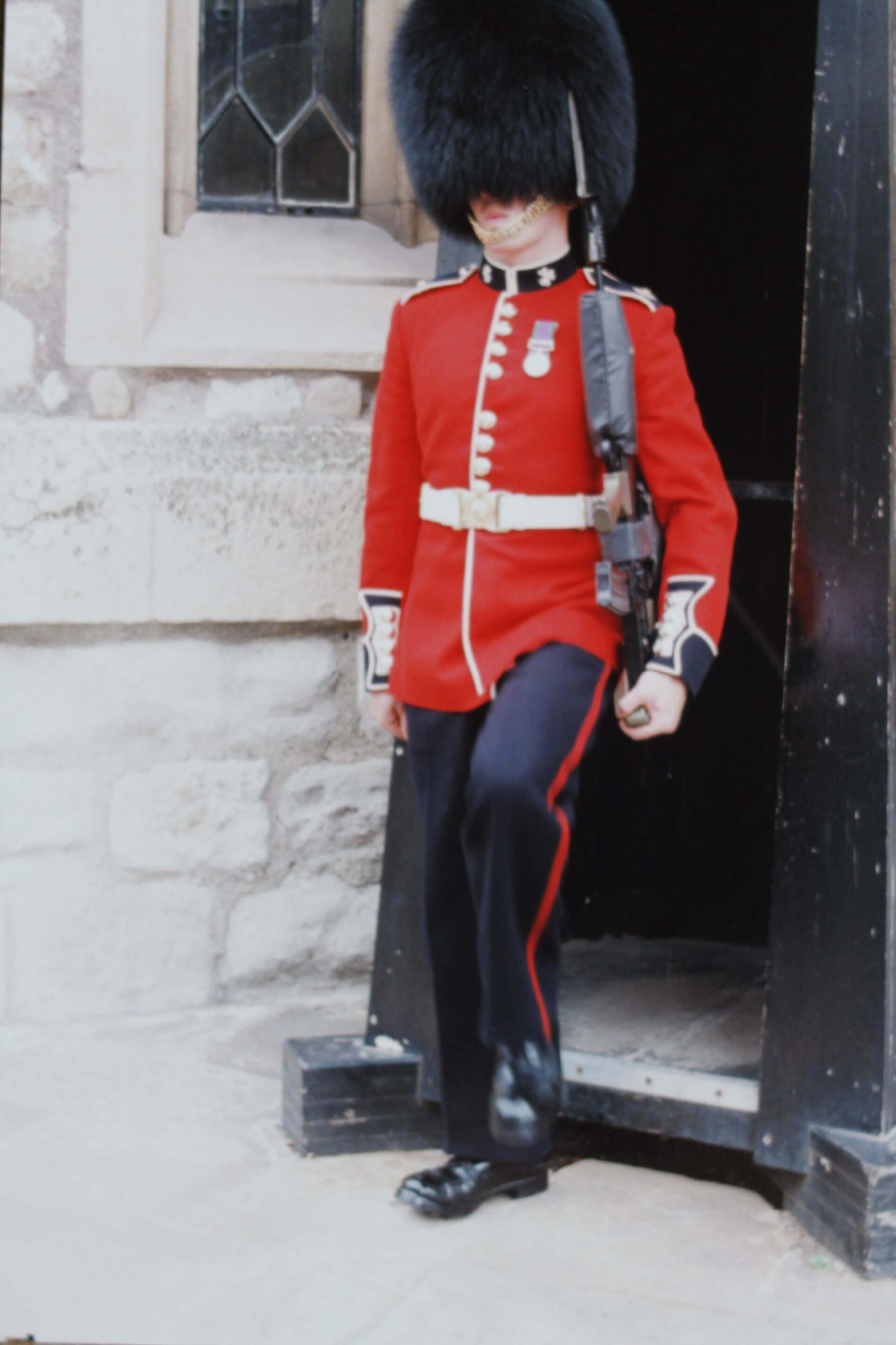 Figure 6 — A ceremonial guardsman of the Grenadier Guards in red tunic and bearskin at the Tower of London in 1993, carrying an SA80, by its date an L85A1. The Guards' sergeant majors had been "having to work…