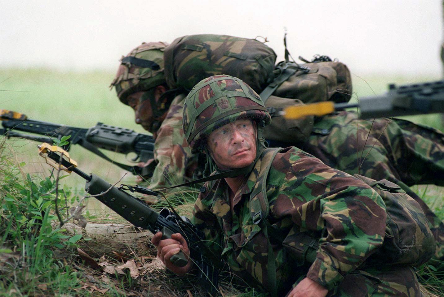 Figure 7 — Gurkha soldiers on exercise in 1998 with L85A1 rifles, one fitted with the yellow blank-firing attachment. US Marine Corps photograph by Lance Cpl. C. D. Clark, public domain.