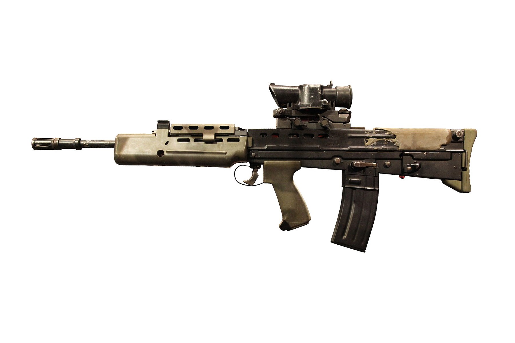 Figure 2 — An L85A1 photographed at the Imperial War Museum, left side, muzzle left, with SUSAT. The A1's green polymer butt and handguard and the magazine behind the grip are visible. Photograph by Rama, CC …
