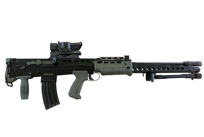Figure 7 — L86A2 Light Support Weapon, right side, muzzle right, with SUSAT, outrigger and bipod, rear vertical grip, and the A2 cocking handle. MOD photograph, Open Government Licence v1.0.
