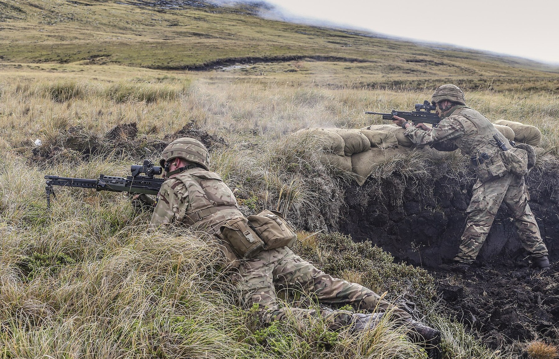Figure 8 — Paratroopers on the Onion Range, Falkland Islands, firing an L86A2 from a peat bank. MOD photograph by Sgt Peter George, Open Government Licence v1.0.