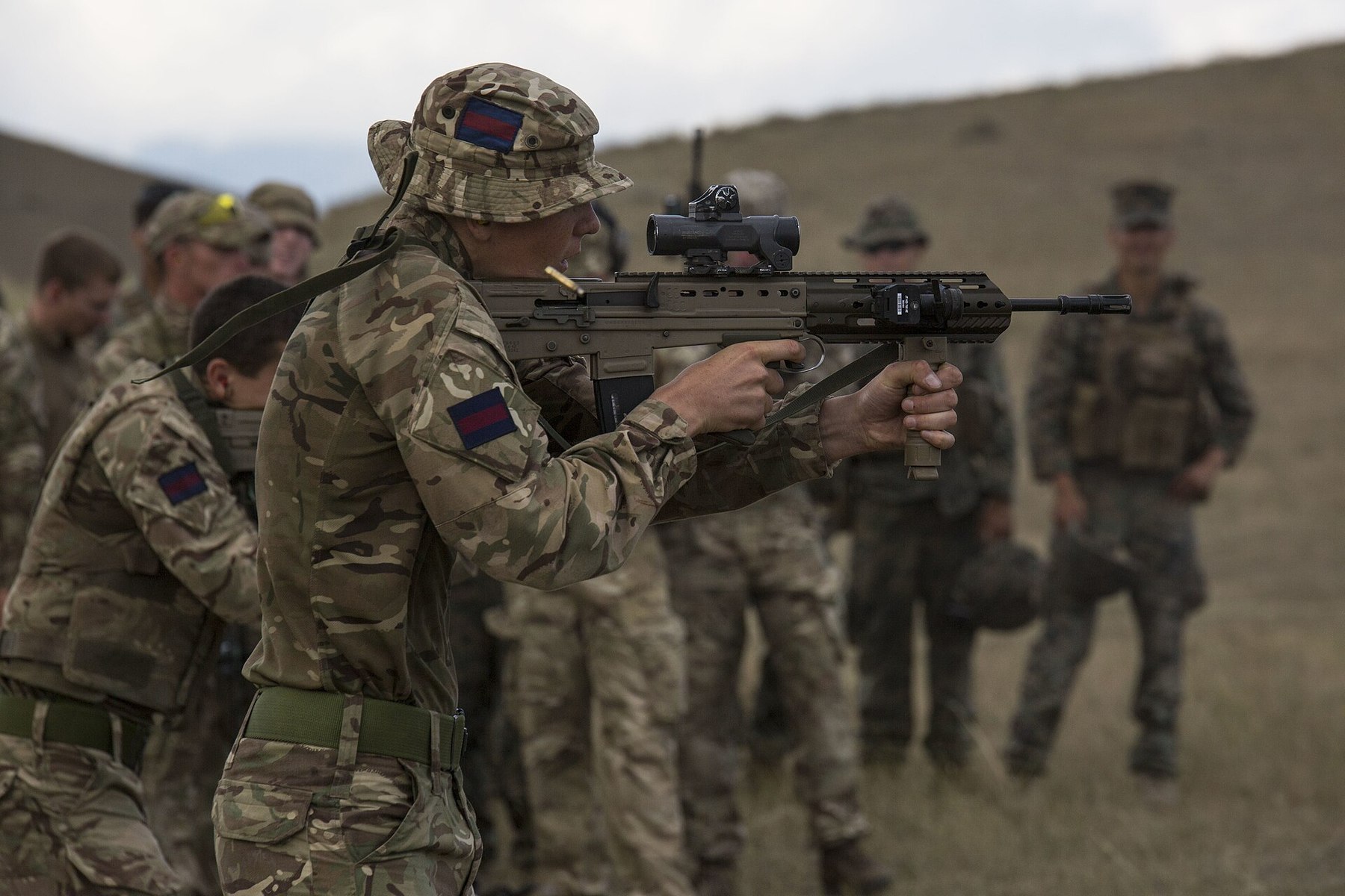Figure 12 — US Marines and British soldiers cross-training on Exercise Agile Spirit 19 in Georgia, 2019; the British soldier in the foreground fires an L85A3 with optical sight. US Marine Corps photograph by L…
