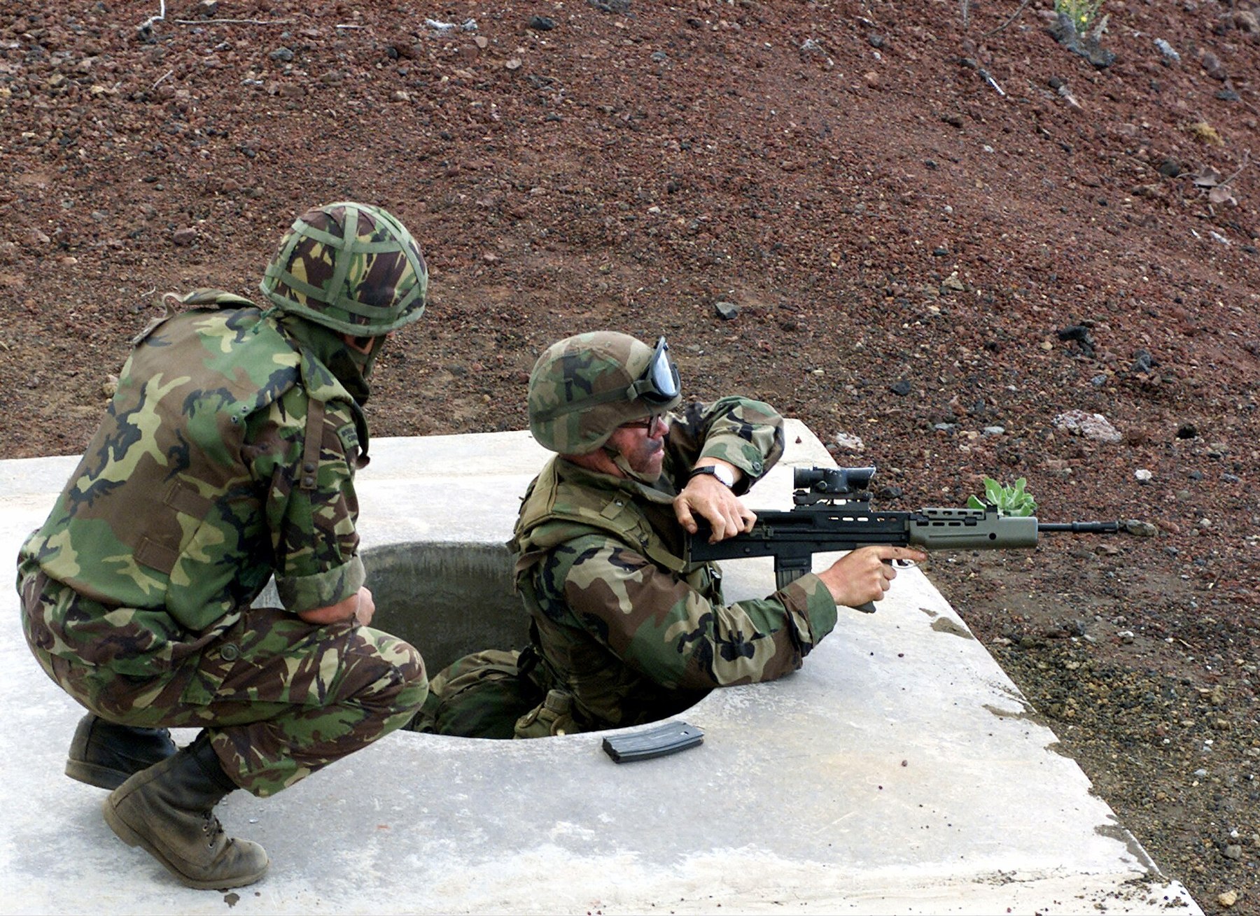 Figure 9 — A US Marine fires an L85A1 from a range position under British instruction, 1990s. US Marine Corps photograph by Lance Corporal Simon Martin, public domain.