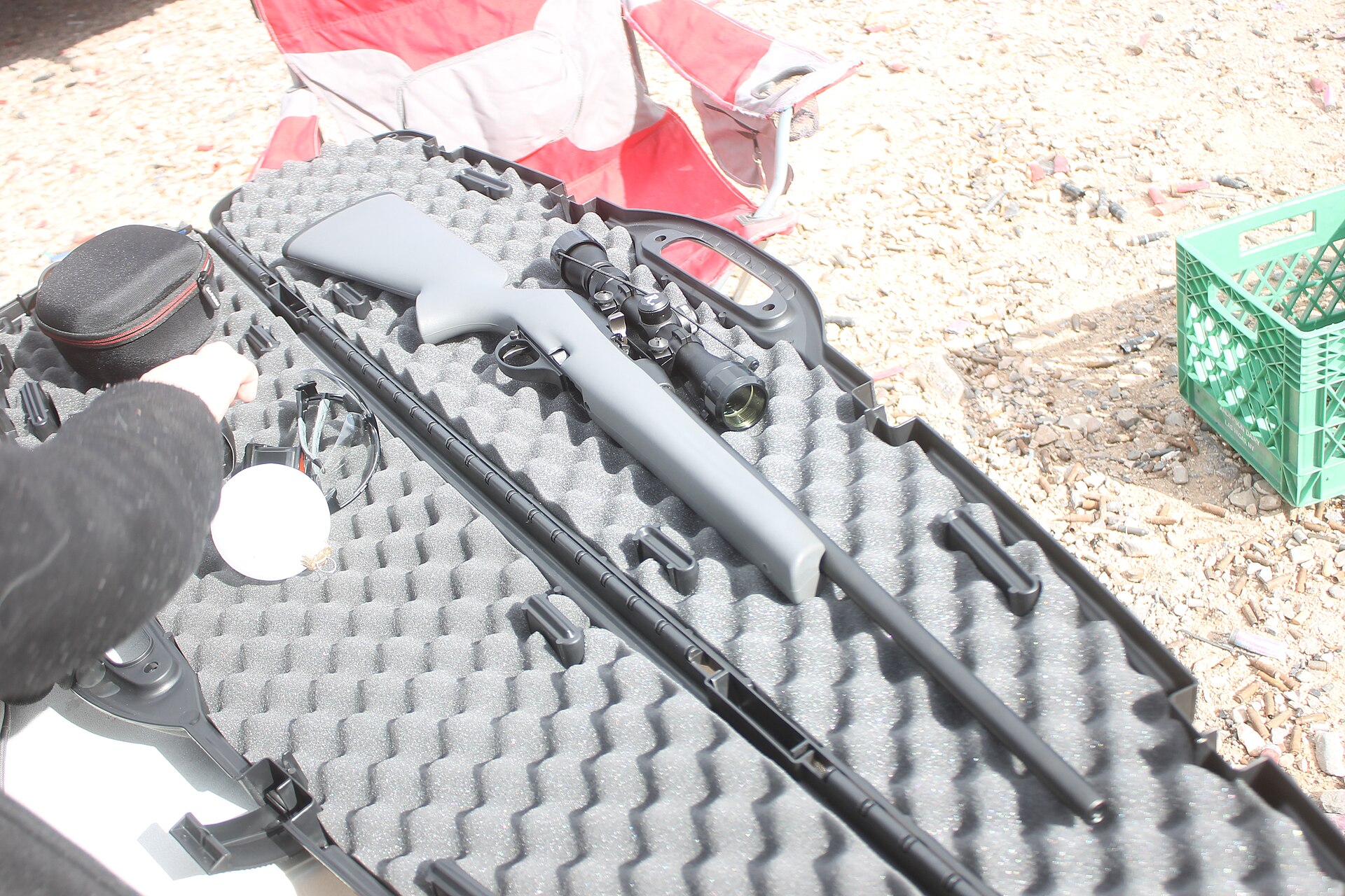 Figure 1 — A Remington Model 597 in its synthetic stock, on its case at an outdoor range. The chambering of this particular rifle is not recorded with the photograph; the 597 family was made in .22 LR and .22…