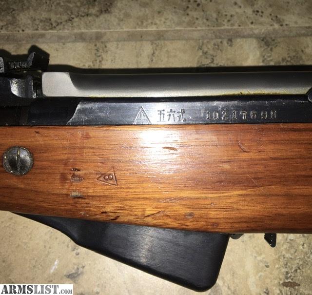 Figure 2 — A Type 56 receiver with the triangle-26 factory mark, the Chinese characters 五六式 ("Type 56"), and the serial number. The same triangle-26 is stamped into the stock below it.