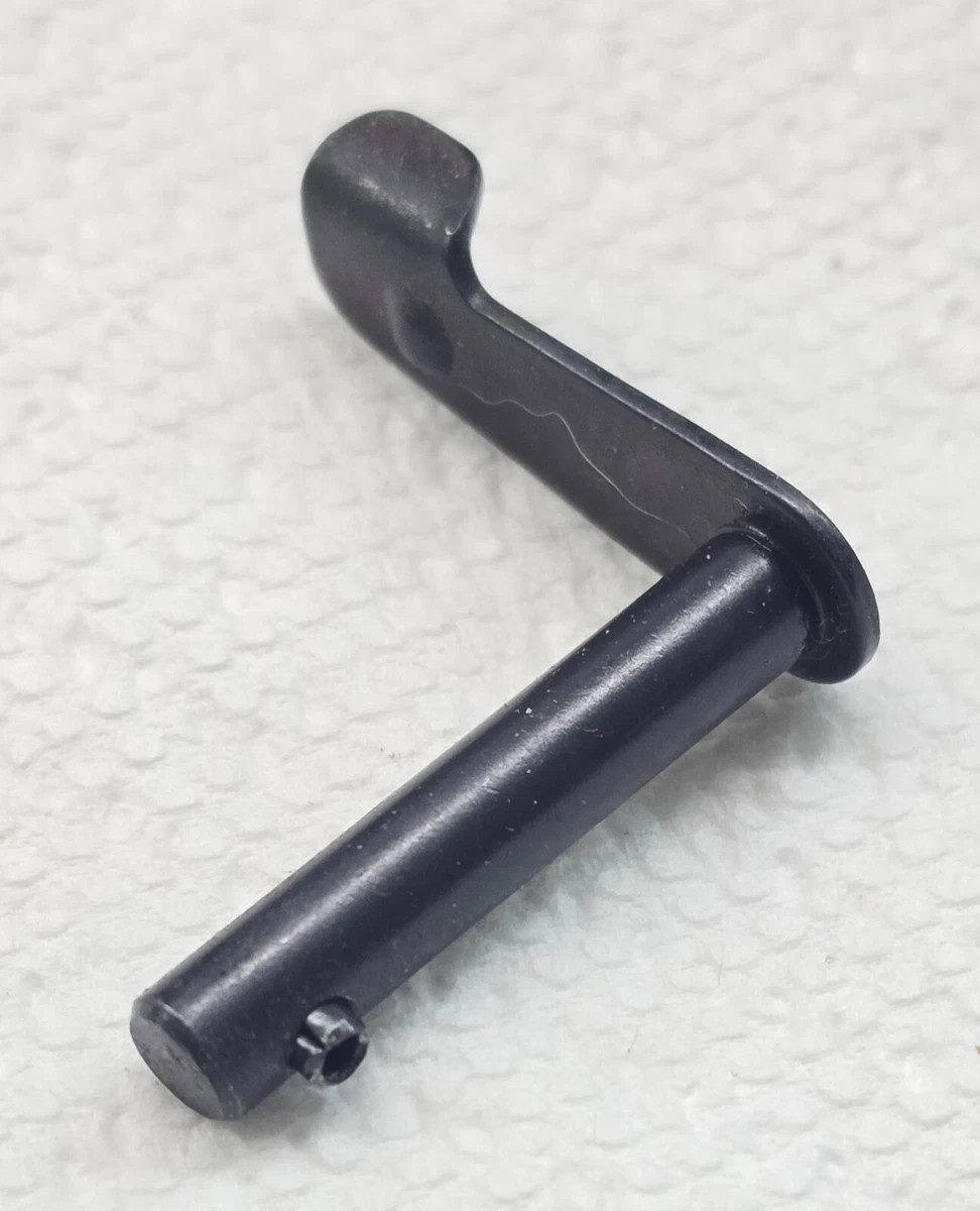Figure 3 — The receiver cover takedown lever, removed from a rifle. This one part is the whole of Step 1 — rotate it up, pull it out.