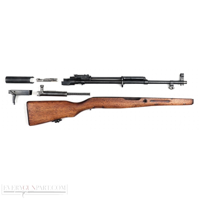 Figure 5 — A Chinese parts kit laid out. Compare the trigger group and gas parts against a Yugoslav kit and the family resemblance is complete — these rifles are the same rifle.