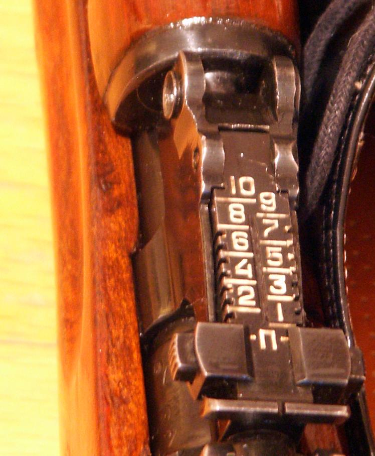 Figure 2 — The SKS tangent rear sight. The Cyrillic "П" sits ahead of the numbered graduations; from there the scale runs 1 through 10, each number a hundred metres.