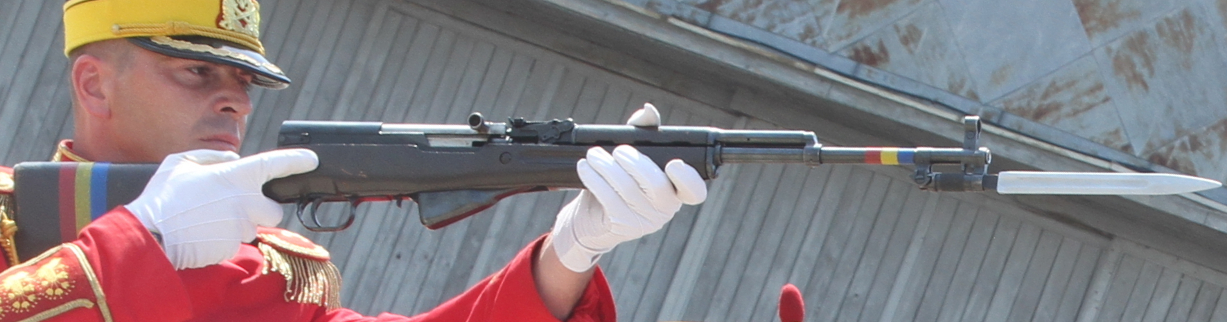 Figure 4 — A Romanian M56 in ceremonial use, bayonet extended. The red, yellow and blue ribbon on the rifle is the giveaway.