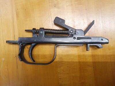 Figure 6 — The same assembly from another rifle. Note the hooks at the front of the housing — they engage lugs on the receiver, which is why the group must be pushed forward before the rear will lift out.