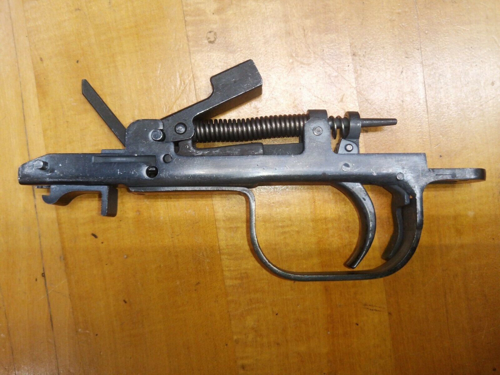 Figure 5 — The SKS trigger group, removed. Hammer, sear, disconnector, springs, safety and the magazine catch, all in one unit that drops out on one latch.