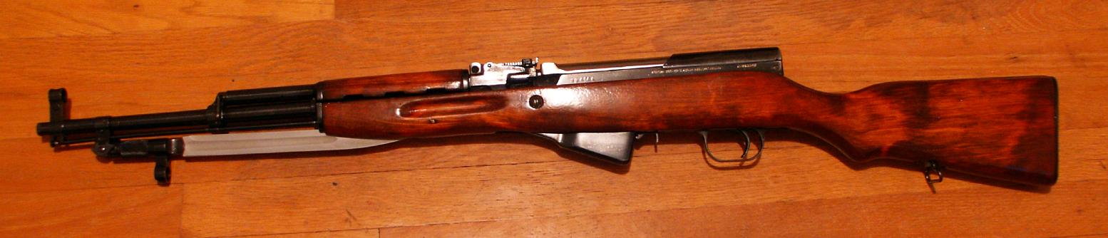 Figure 2 — A 1954 Tula SKS, left side. Blonde stock, blade bayonet, cleaning rod visible under the barrel.