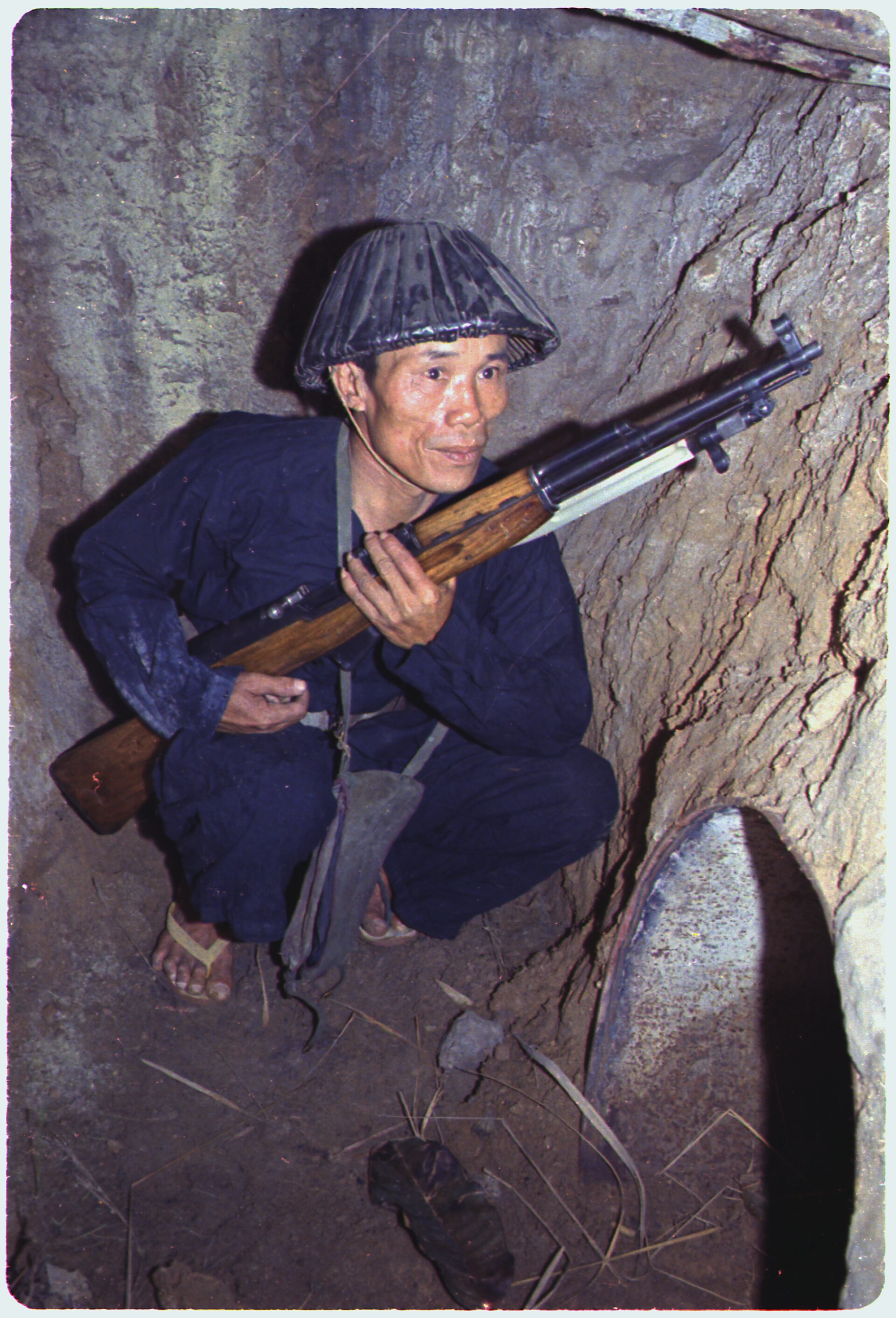 Figure 5 — A Viet Cong soldier in a bunker with an SKS. National Archives photograph.