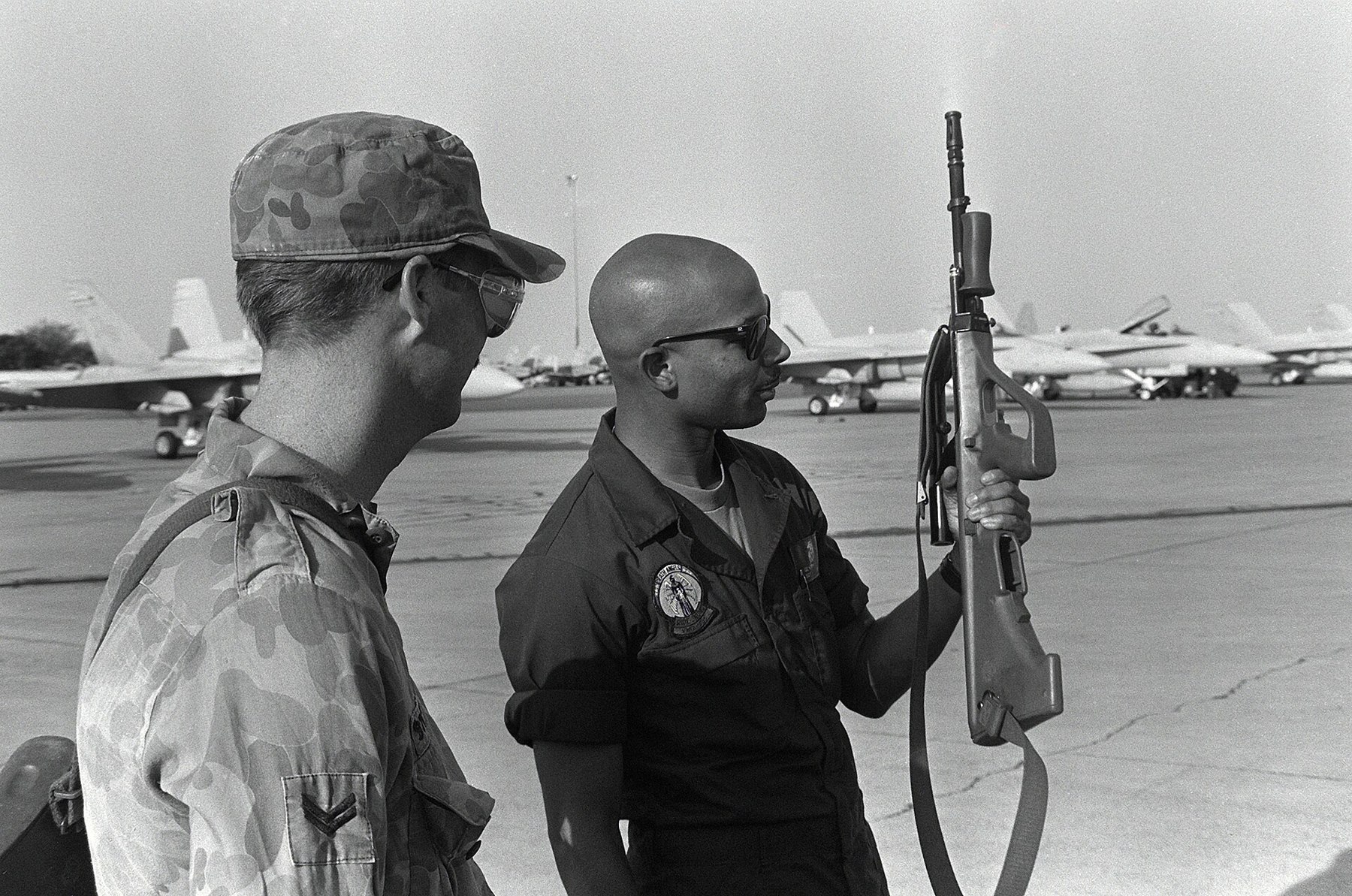 Figure 4 — An Australian corporal of the 5th Aviation Unit instructing a US Marine on the F88 in October 1992, four years after the first deliveries. The F88 is the AUG with the integral 1.5× optic. Photograp…